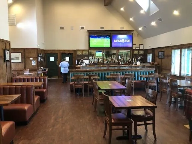 Spacious interior featuring a vaulted ceiling and wood-finish flooring