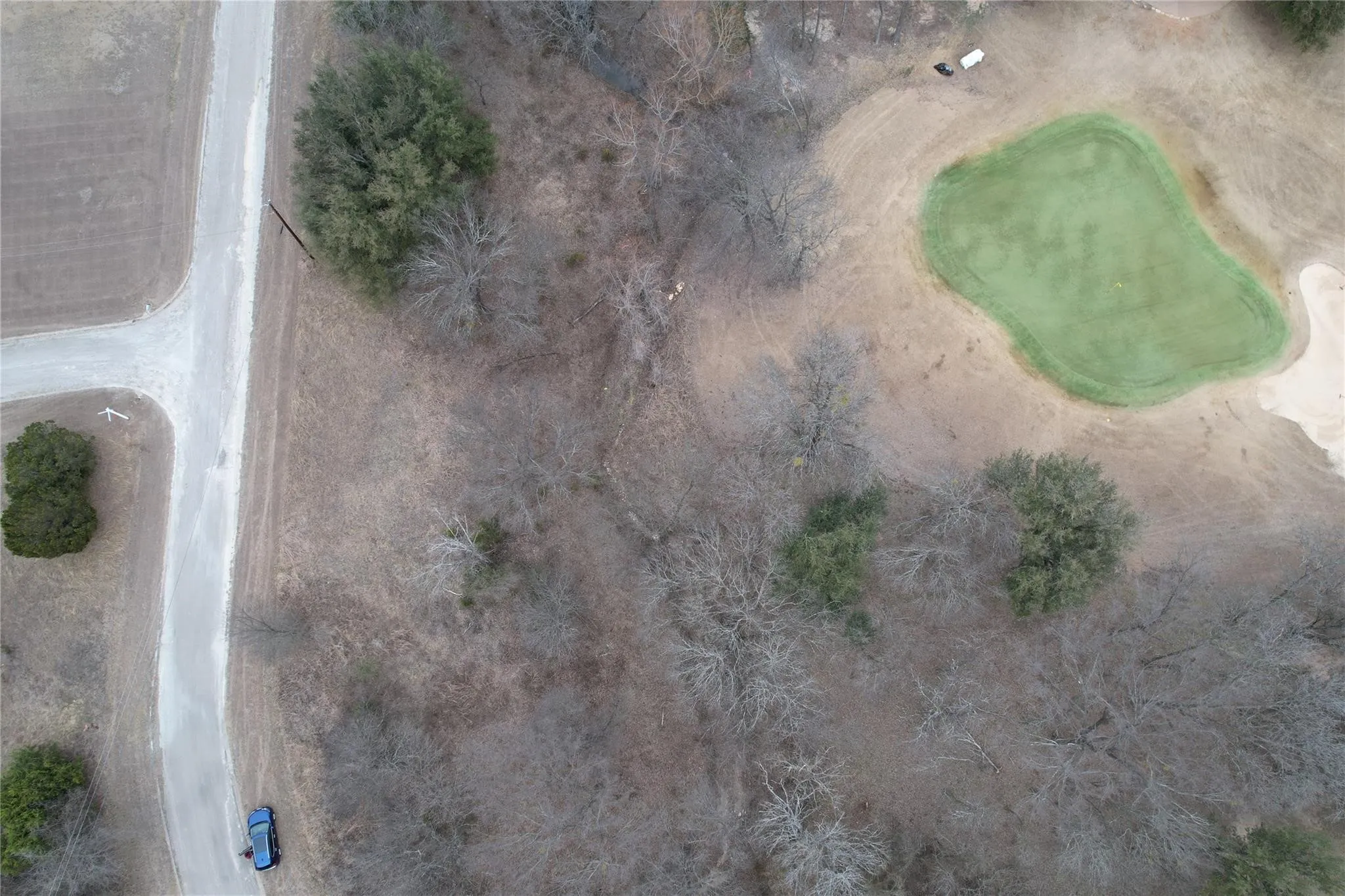 Expansive land parcel featuring natural terrain and mature trees