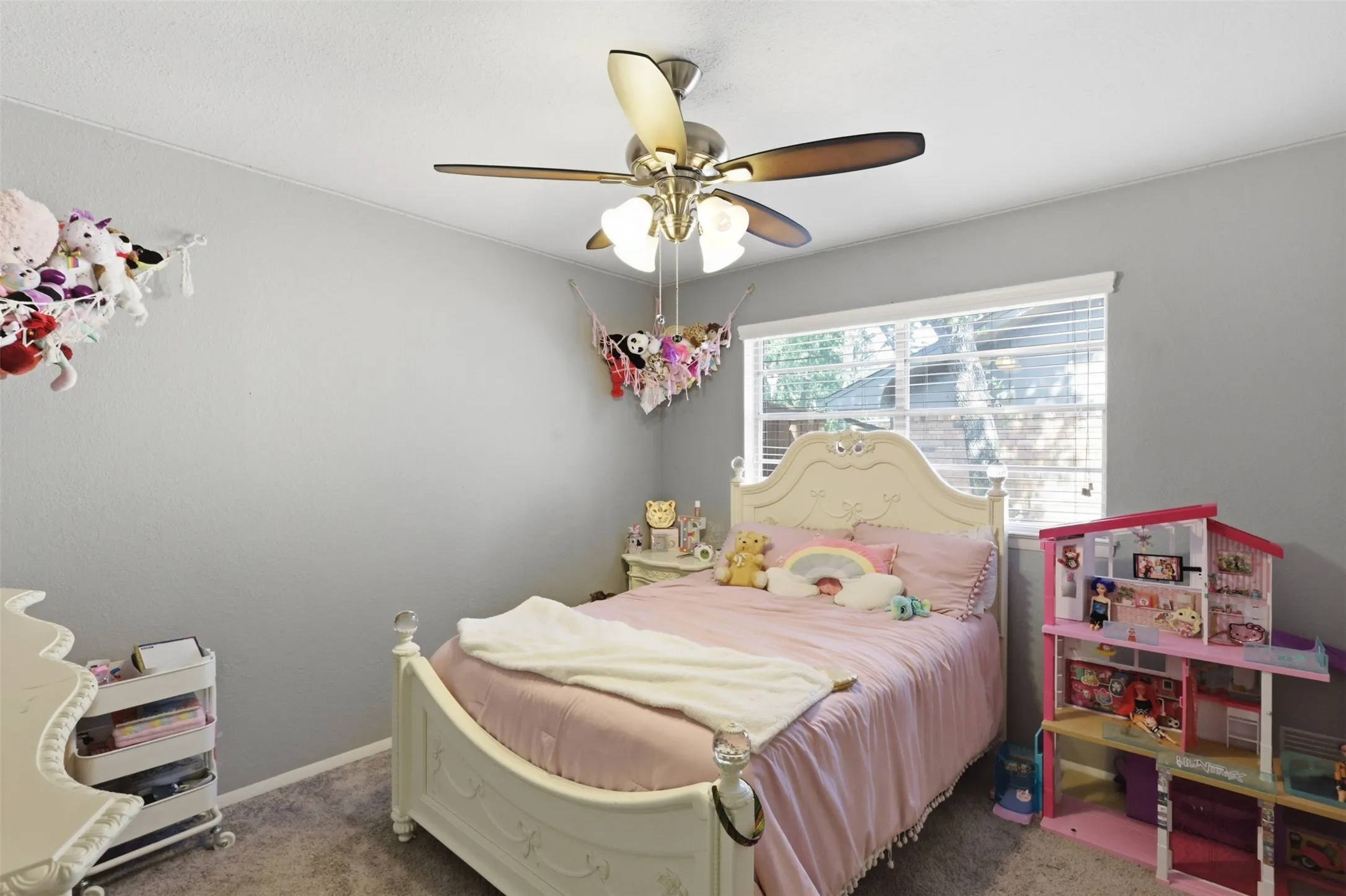 Comfortable secondary bedroom with natural light and neutral finishes.