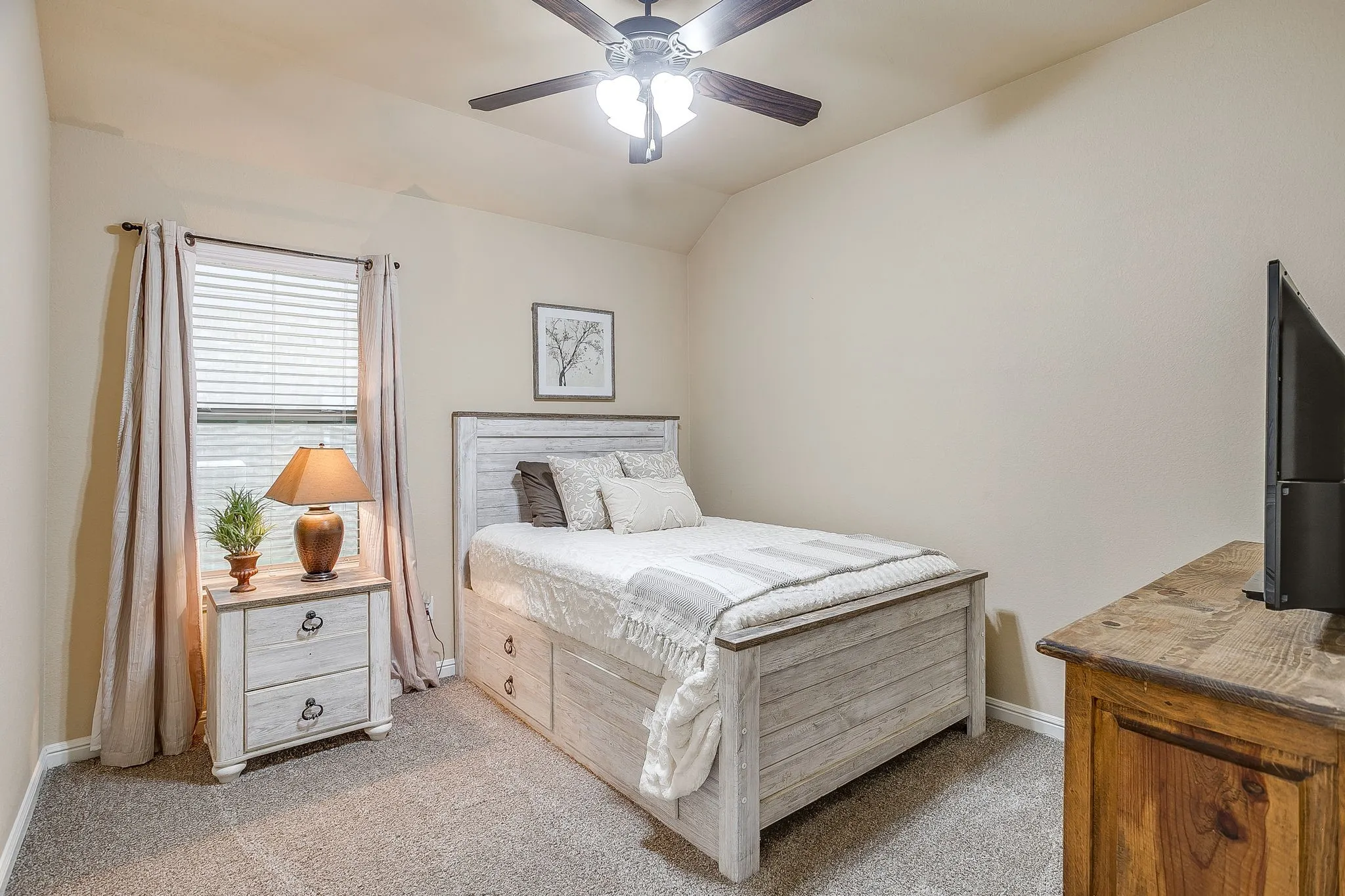 Carpeted room featuring a window with blinds and drapery, a ceiling fan with integrated lighting, and neutral wall tones