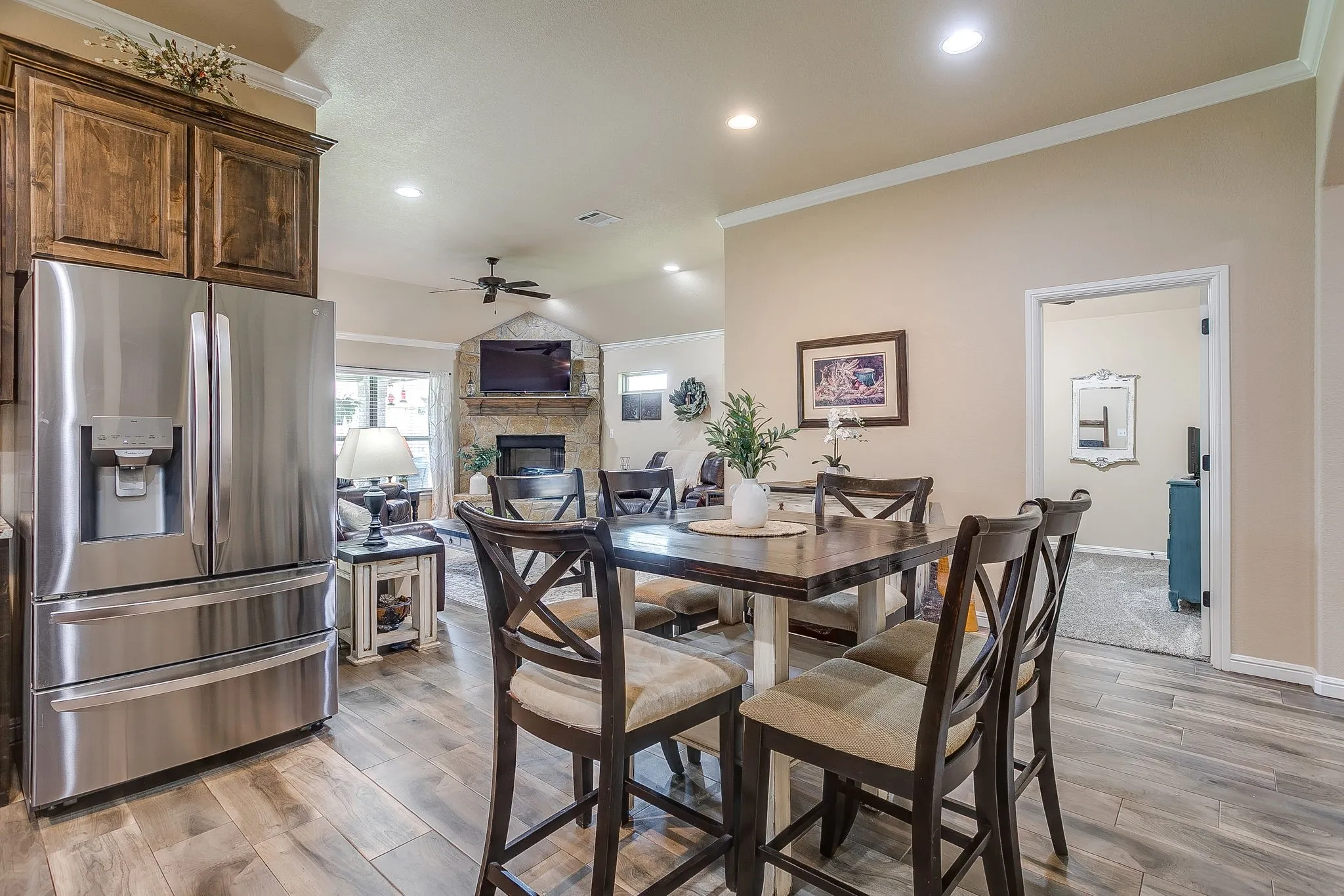 Dining area featuring wood-finish flooring, recessed lighting, and crown molding