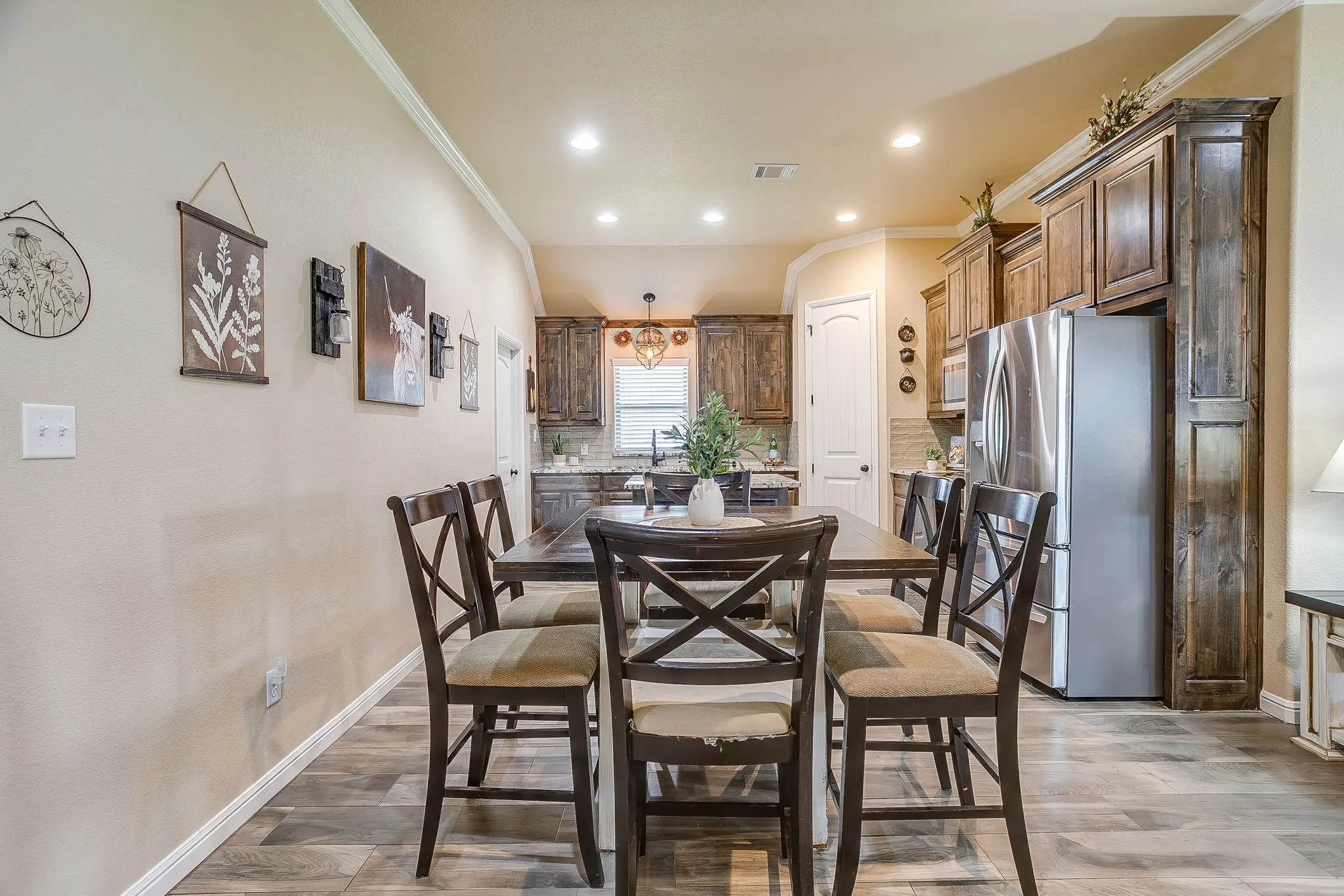 Living area featuring a vaulted ceiling with a ceiling fan, recessed lighting, and wood-finish flooring