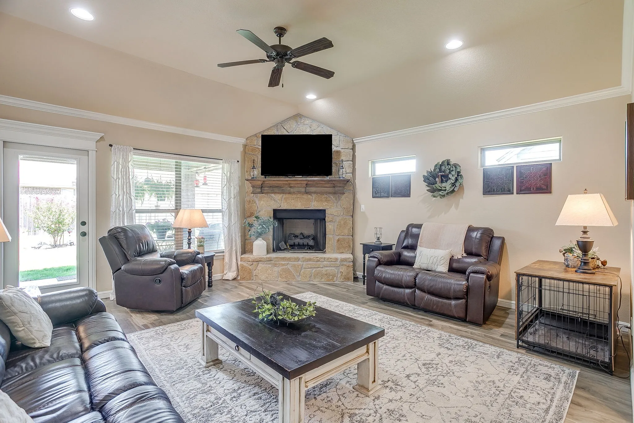 Open-concept living area featuring wood-finish flooring, recessed lighting, and crown molding
