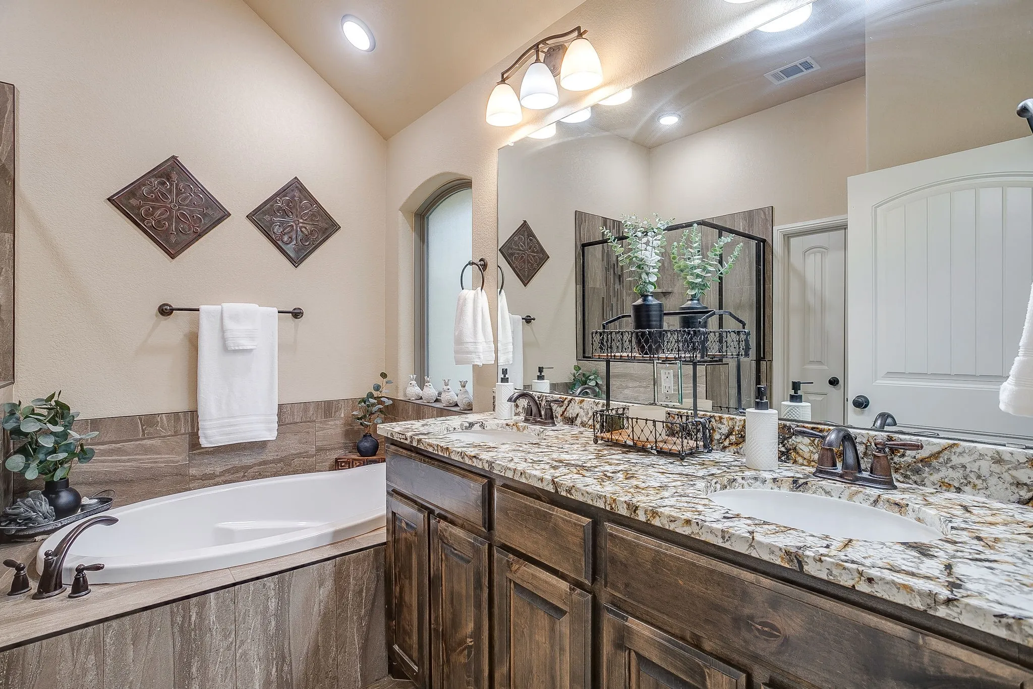 Dual vanity with granite countertops, undermount sinks, and bronze-finish fixtures