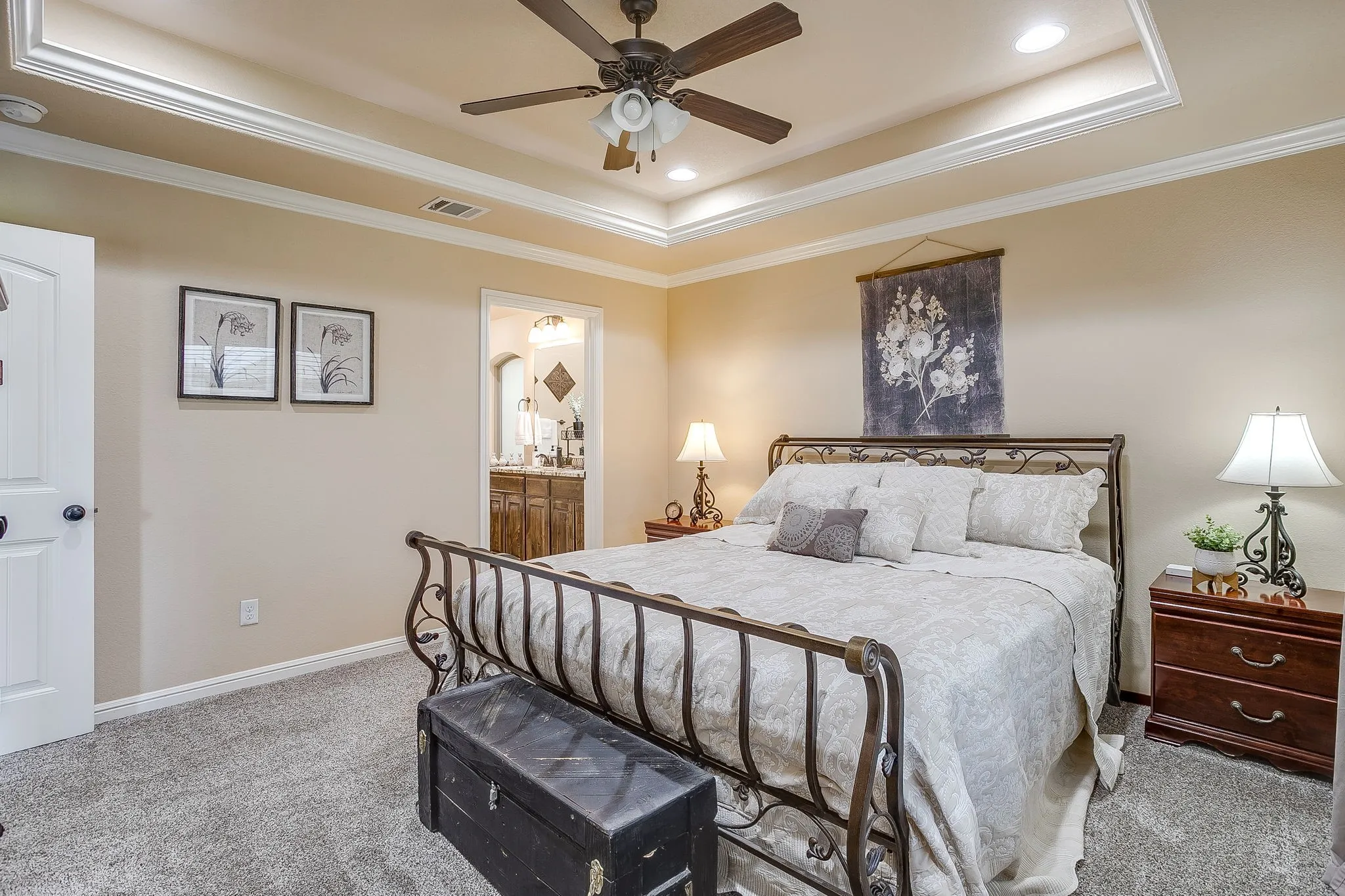 Bedroom featuring a recessed tray ceiling with crown molding, ceiling fan, and recessed lighting