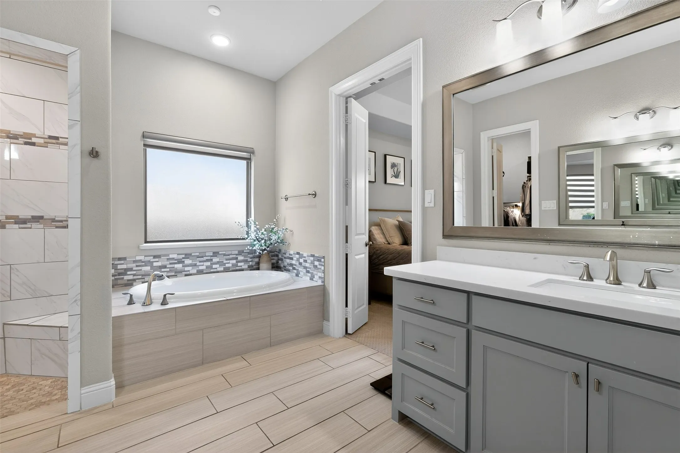 Carpeted bedroom featuring a vaulted ceiling with a ceiling fan, a window, and light gray walls