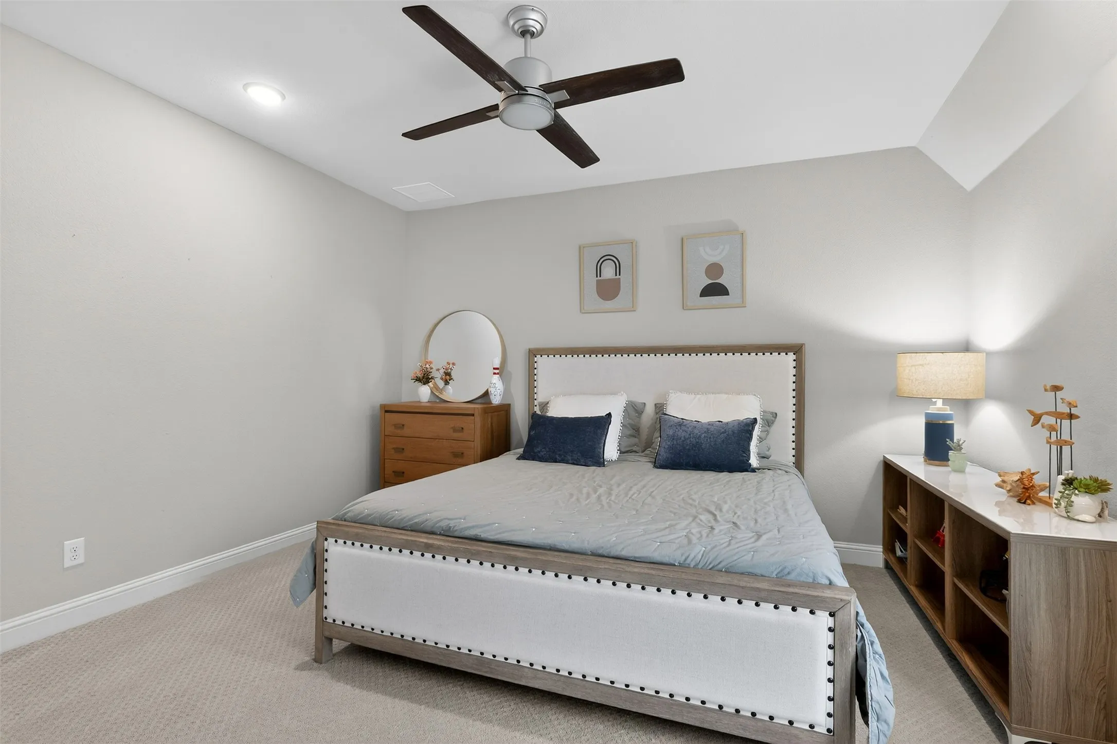 Carpeted bedroom featuring a ceiling fan with light fixture, recessed ceiling lighting, and a neutral color palette