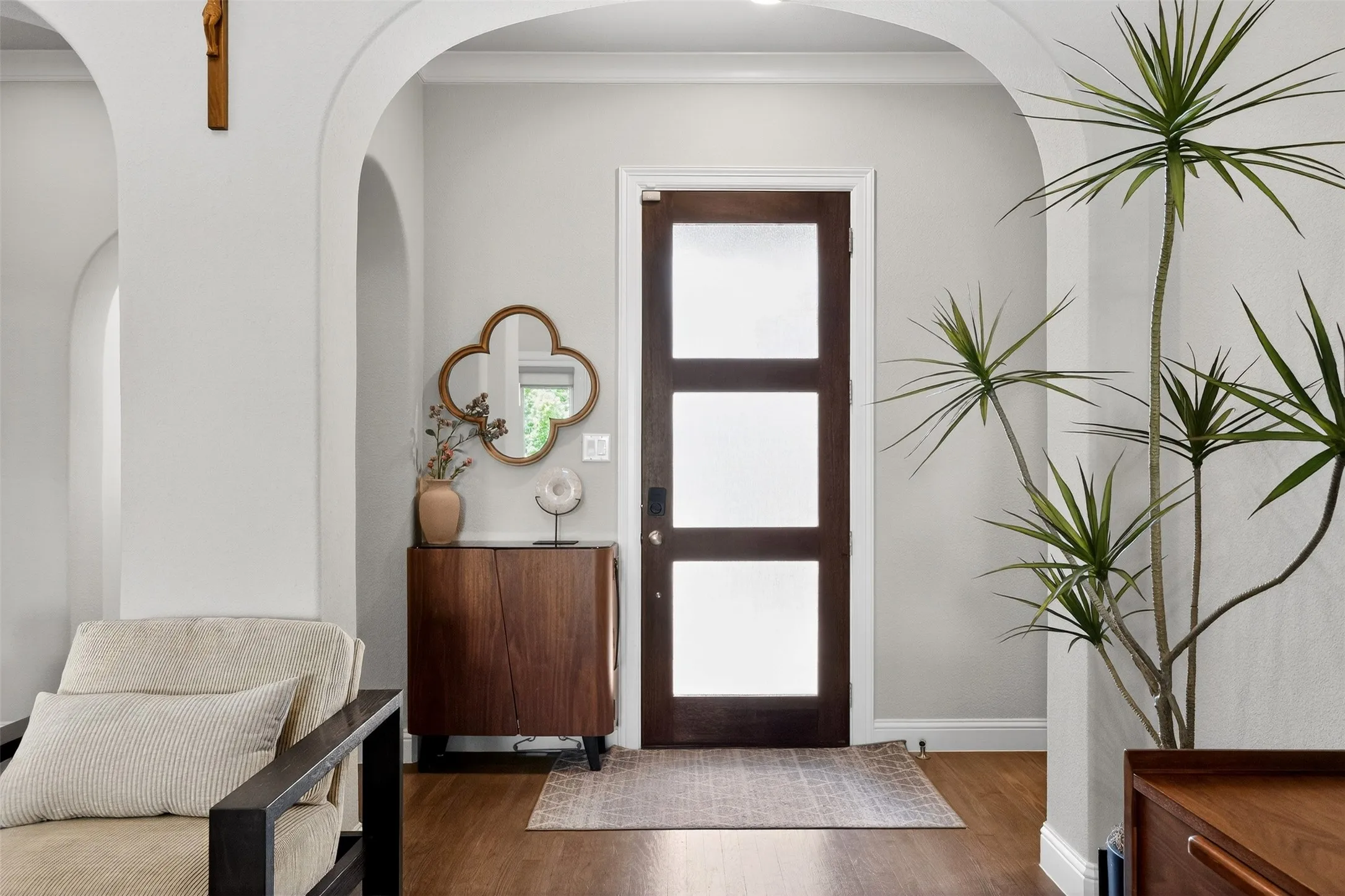 Entryway featuring a rich wood-paneled door with three frosted glass inserts