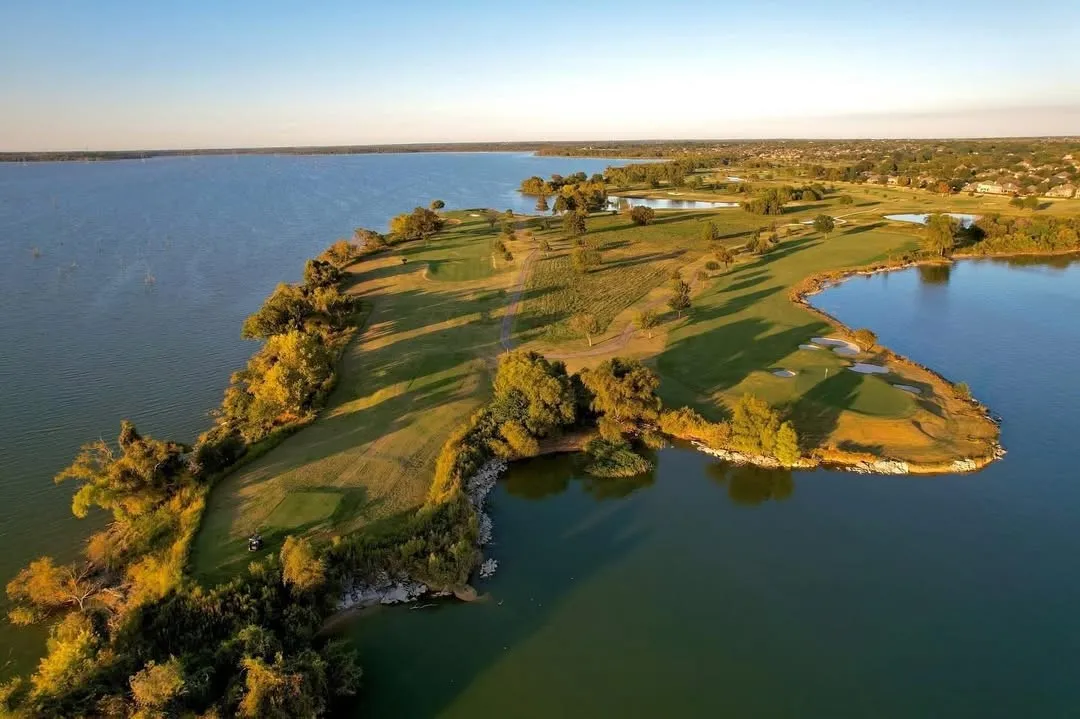 Expansive golf course property featuring waterfront access and mature trees