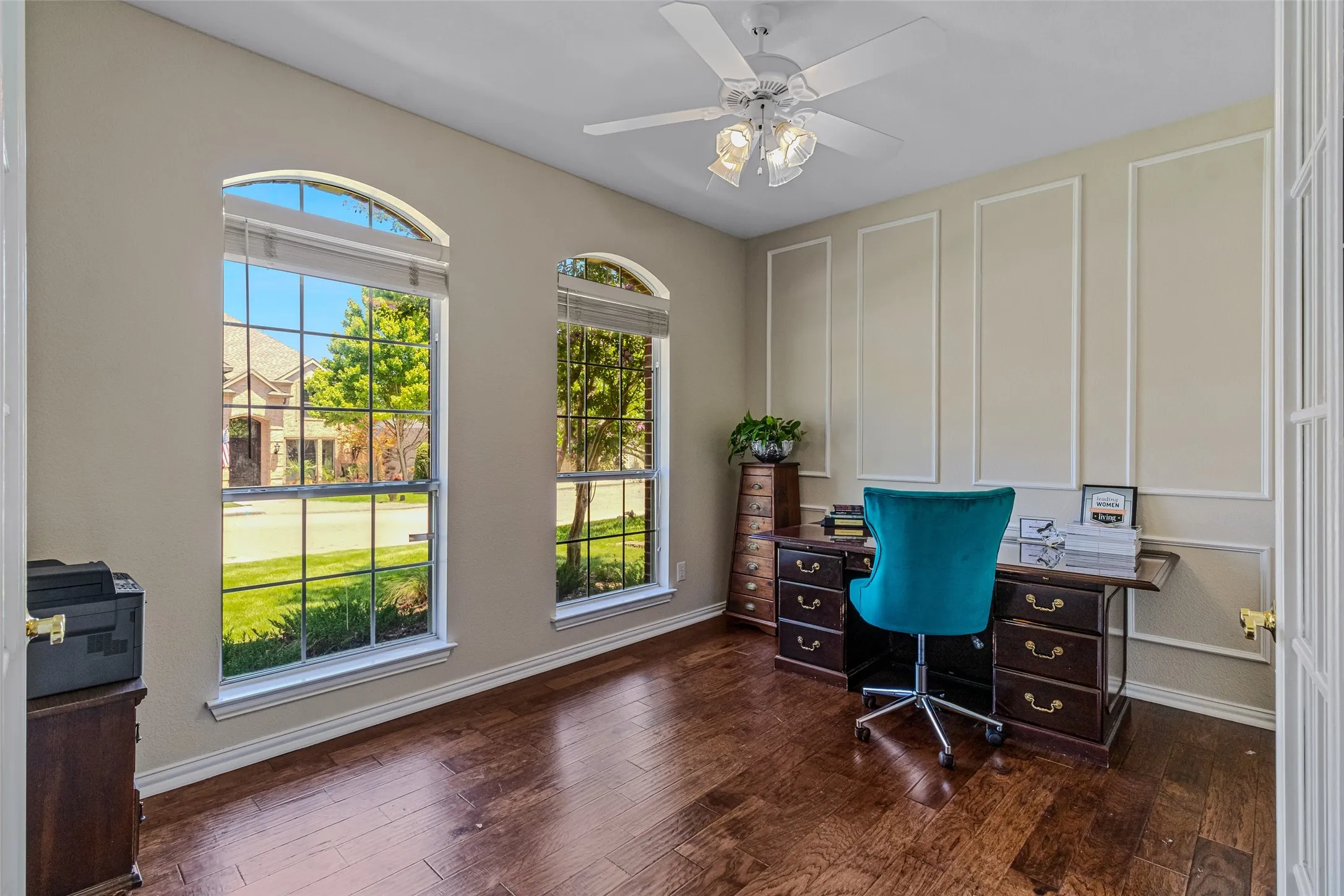 Rich wood-finish flooring complements the wall paneling and trim work in this space