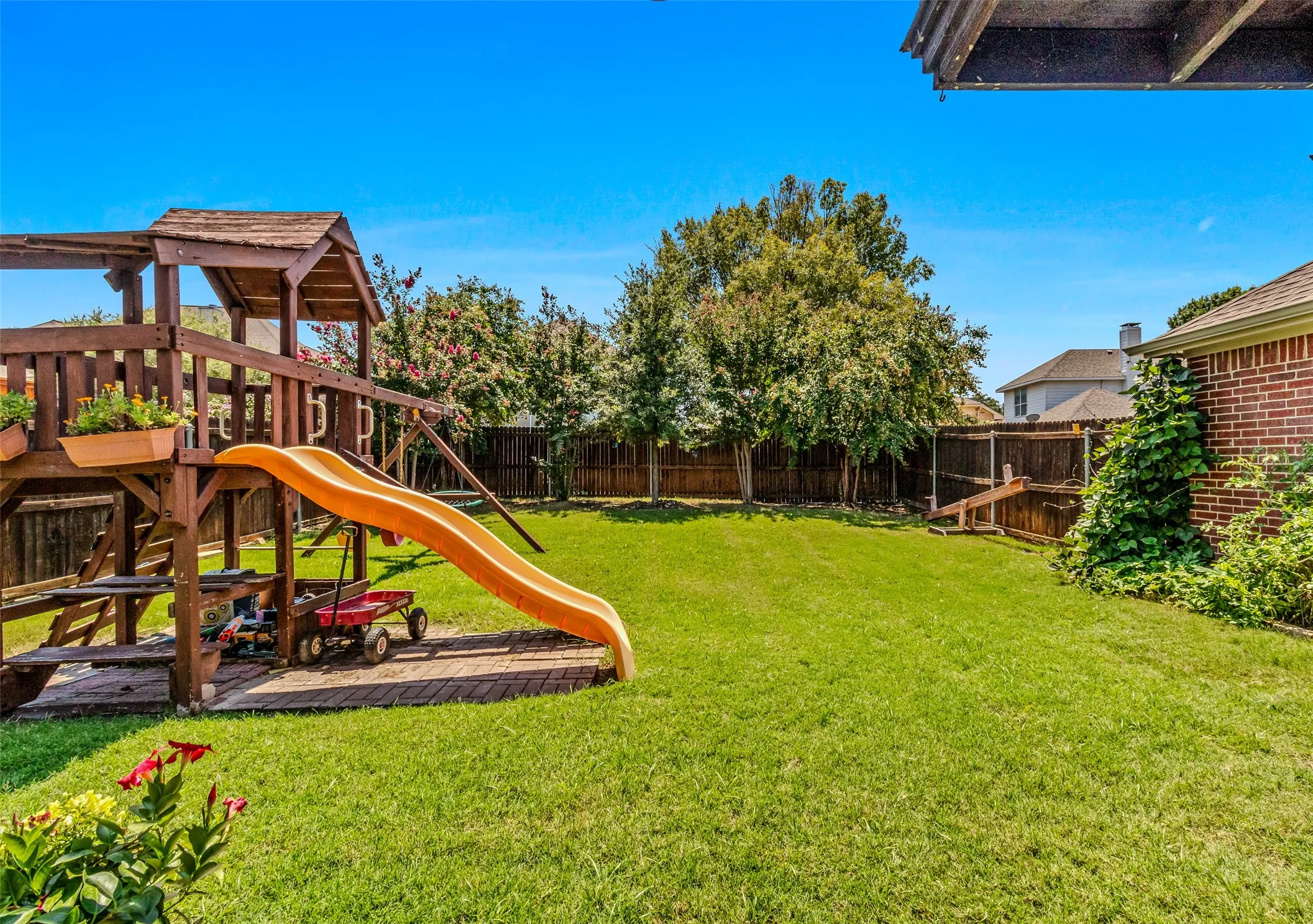 Expansive green lawn with a privacy fence