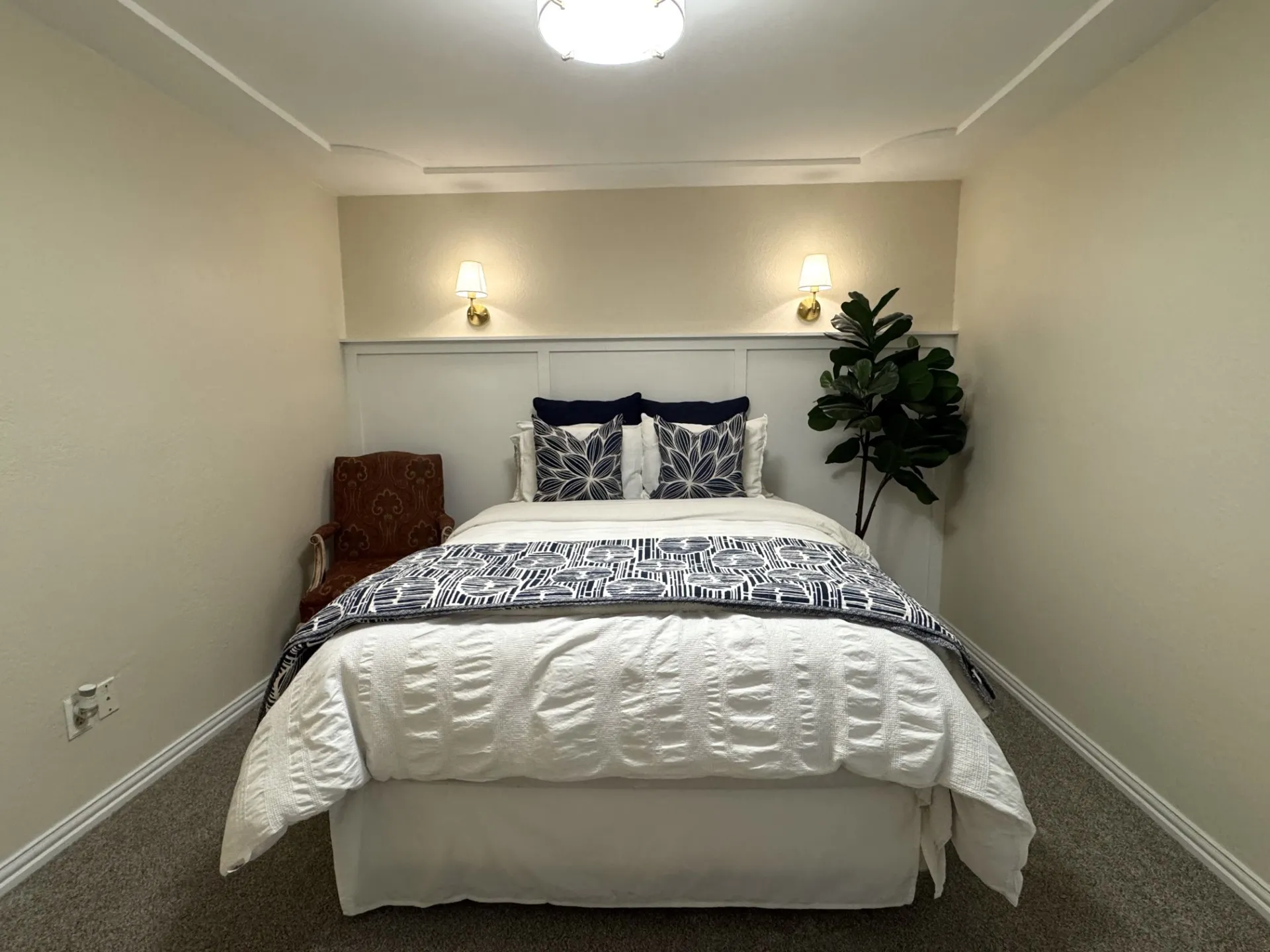 SPLIT Bedroom 2 featuring a paneled accent wall with integrated sconces, ceiling lighting, and crown molding