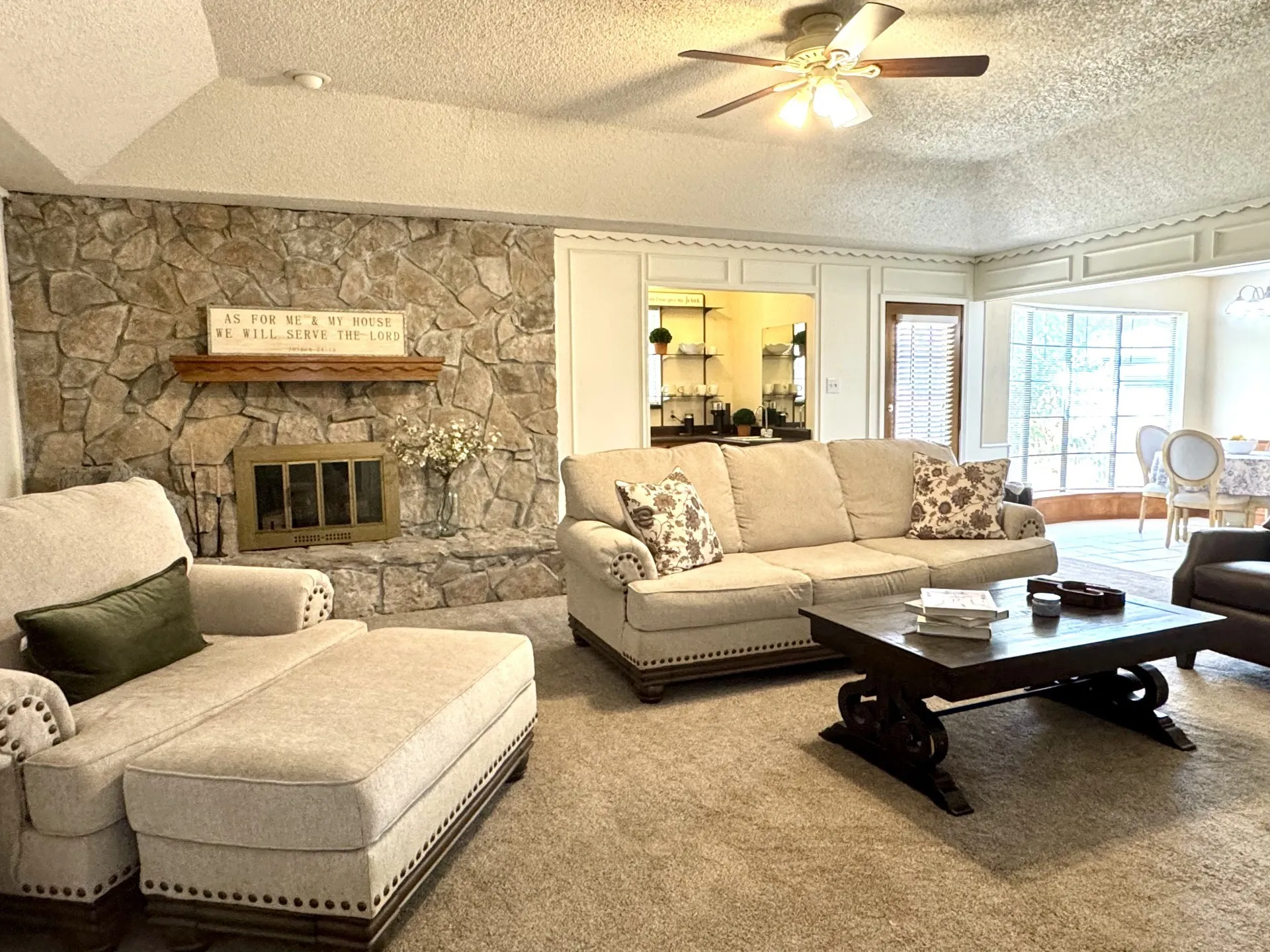 Spacious living area featuring a STONE fireplace with GAS LOGS... hook-up for Propane Tank outside OR Wood-Burning.