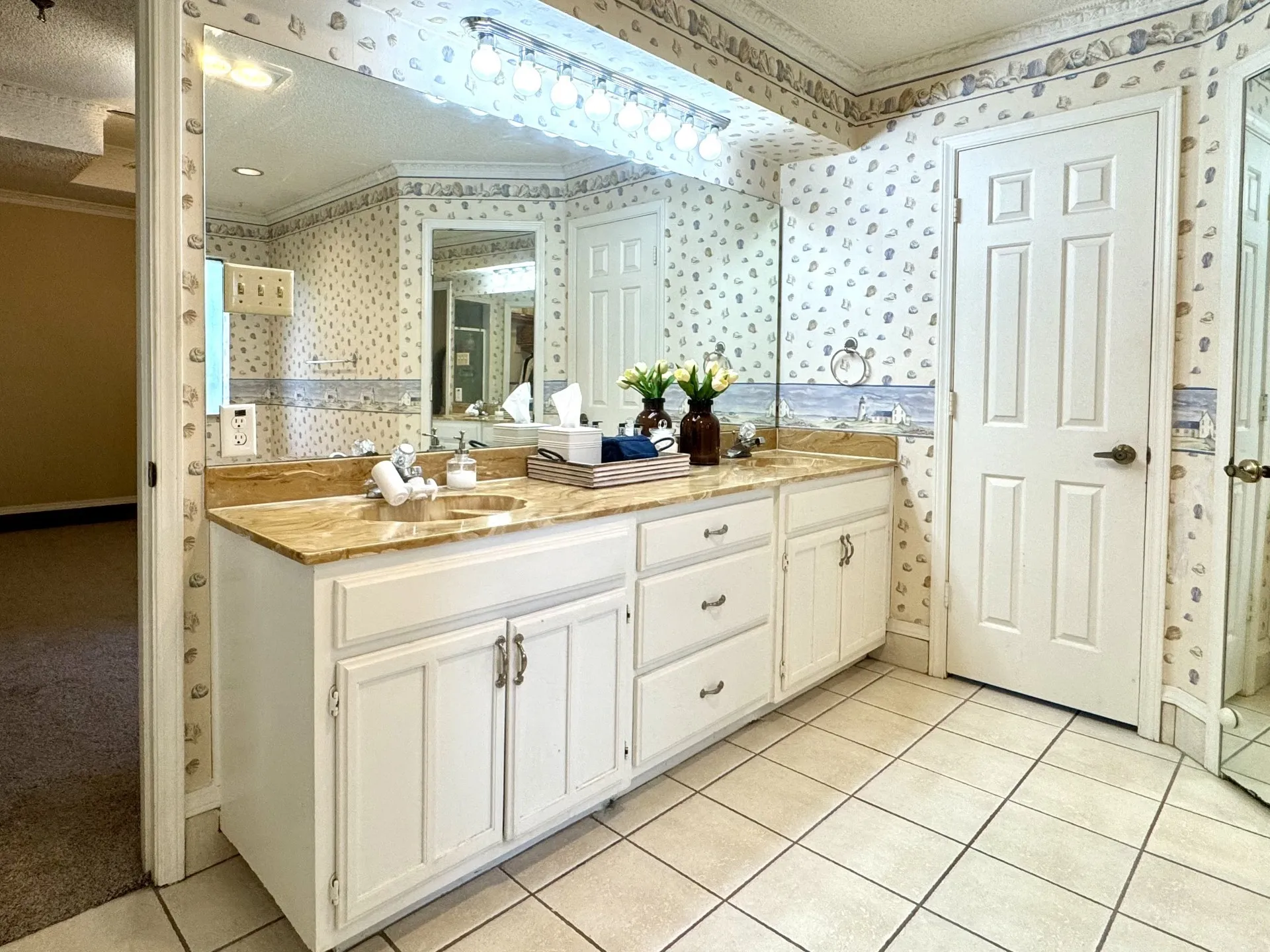 Dual Sink Vanity with a marble-finish countertop, and ample storage cabinetry... Door to Private Potty Area on the Right