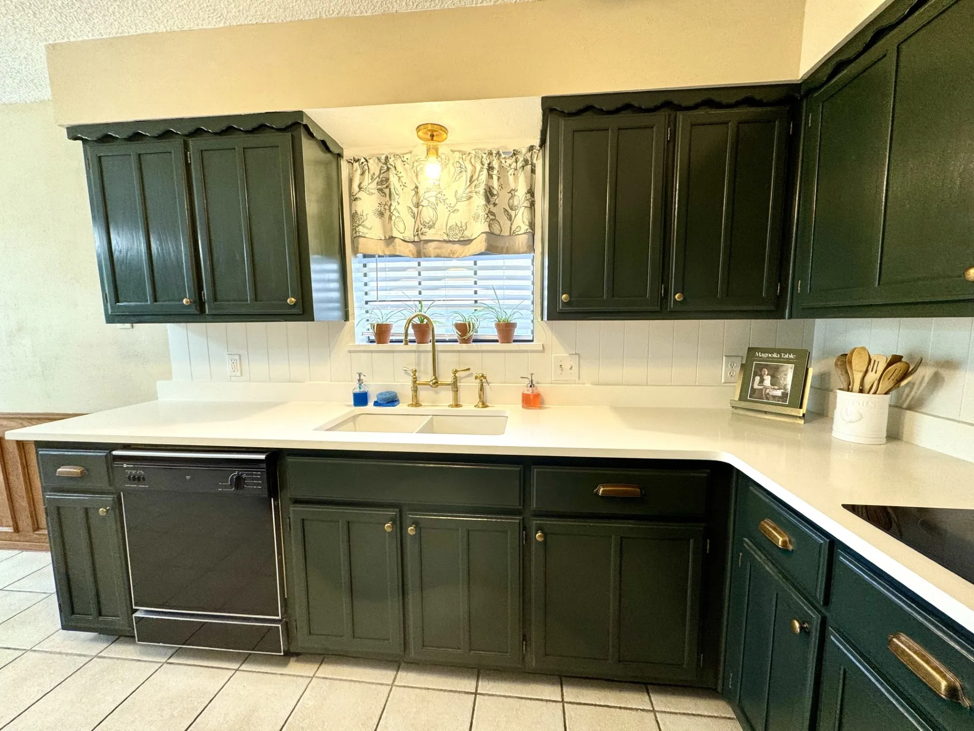 Magnolia-Inspired dark green kitchen cabinetry with brass hardware, white Quartz countertops, and beadboard backsplash... Dishwasher & Disposal too!