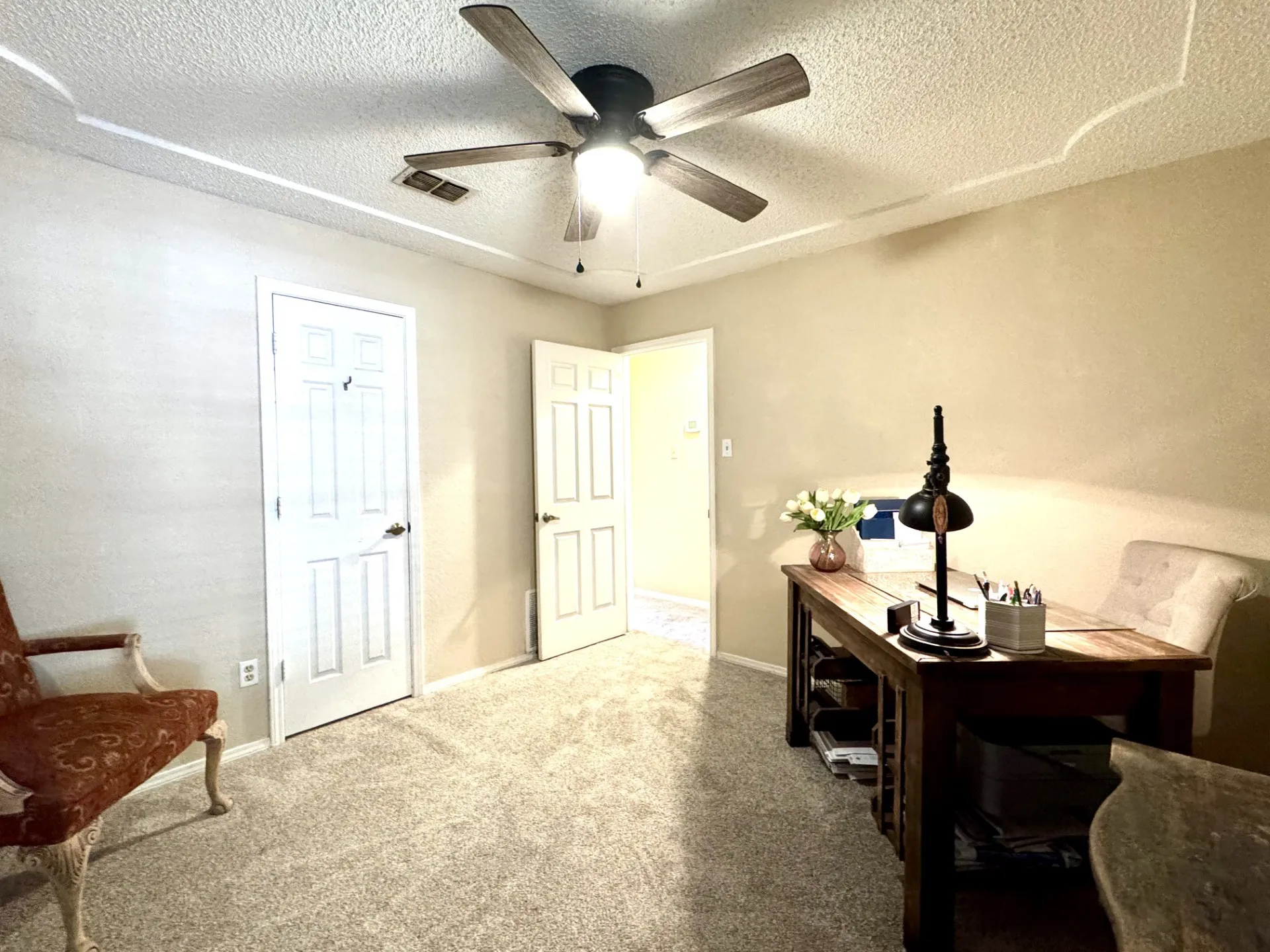 Bedroom 2 features nice carpeting, a ceiling fan with integrated lighting, textured ceilings, and painted walls