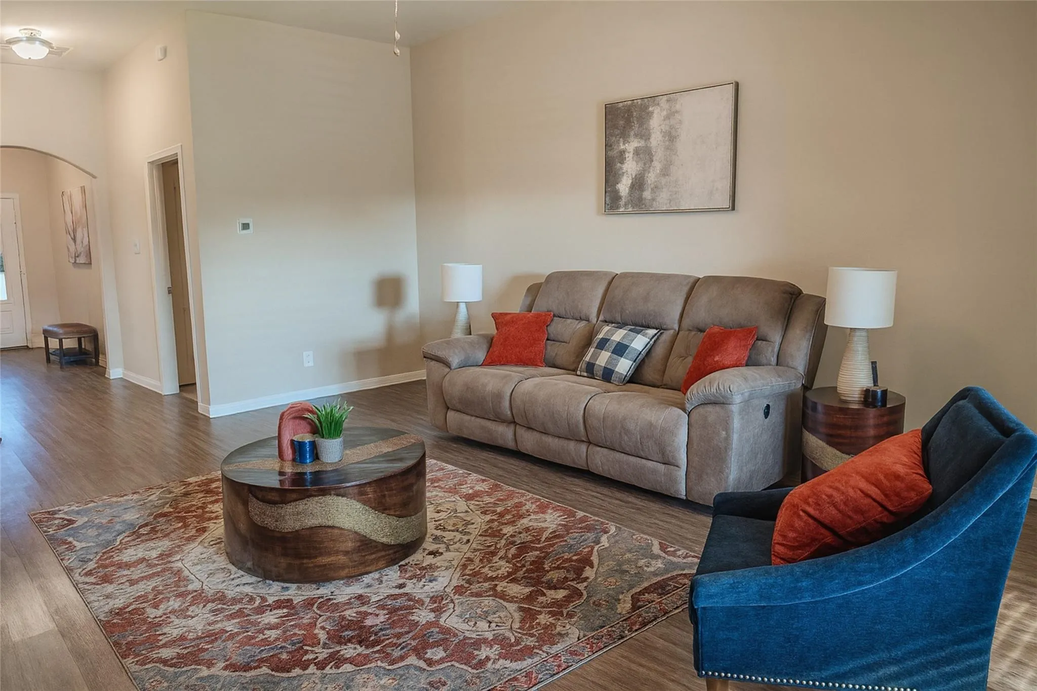 Open-concept living area featuring wood-finish flooring, neutral wall tones, and recessed lighting