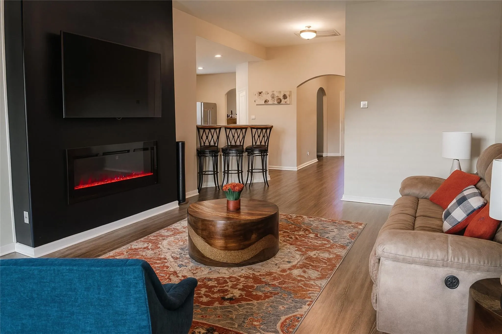 Modern living area featuring wood-finish flooring and neutral wall tones