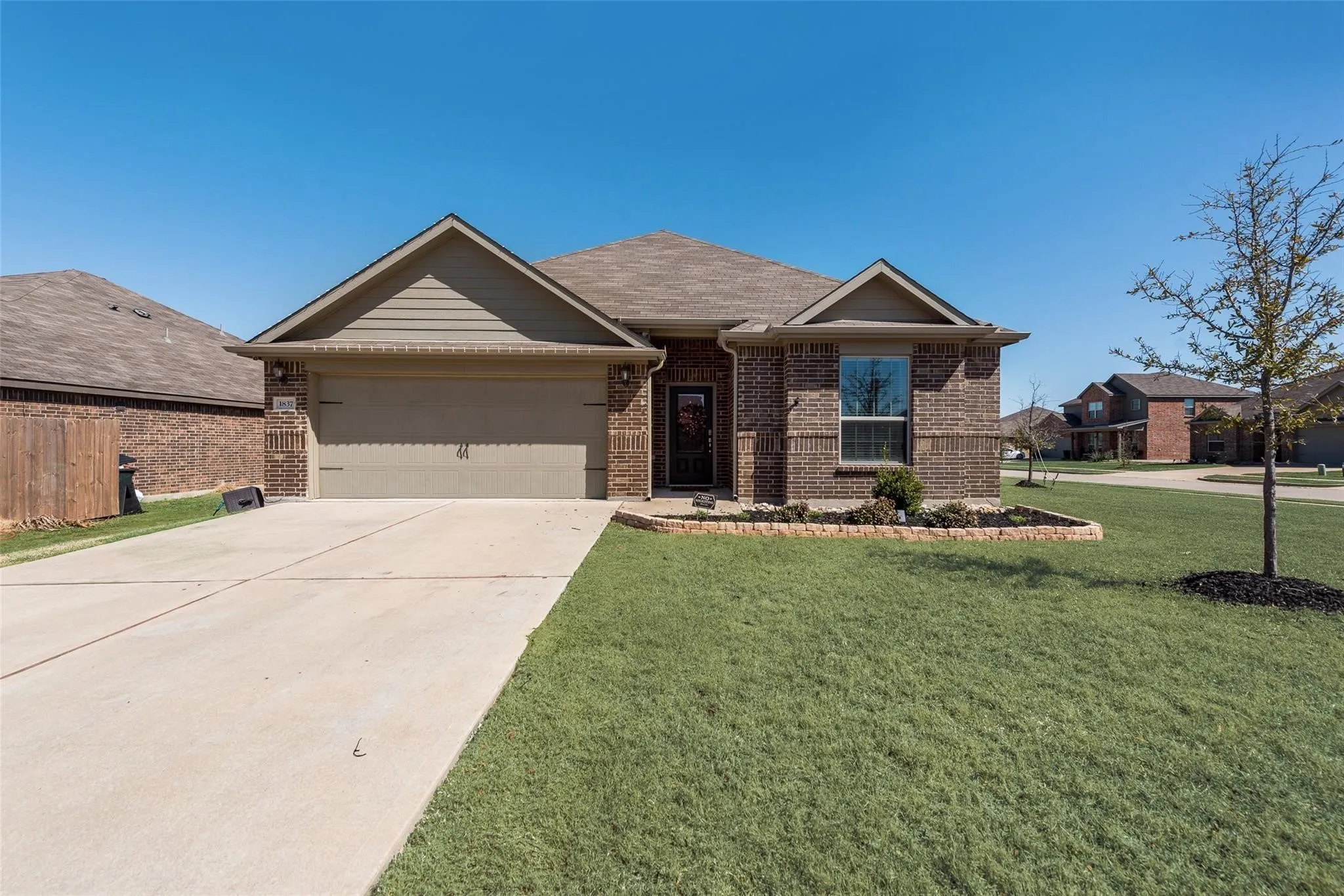 Brick exterior with an attached two-car garage