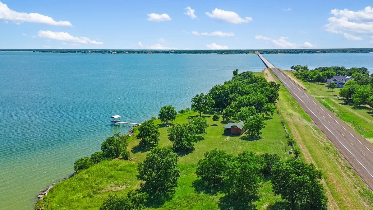 Expansive waterfront property featuring a private boat dock with covered slip