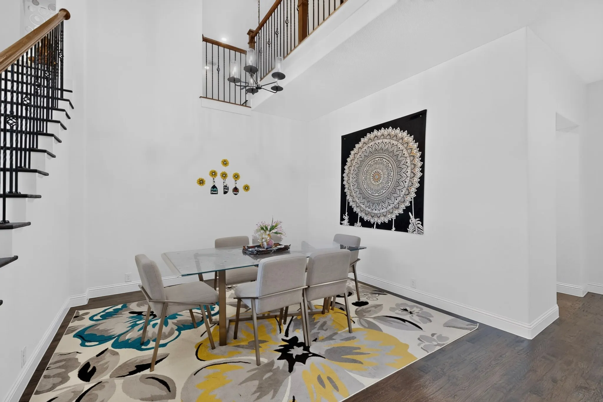 Double-height ceiling dining area featuring wood-finish flooring