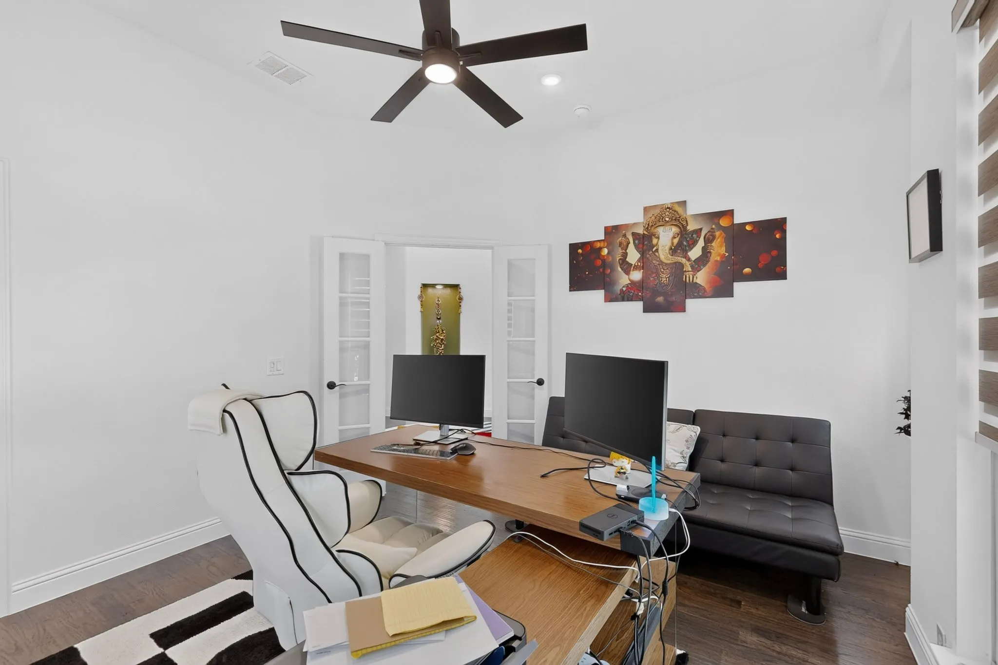 Dedicated room featuring dark wood-finish flooring and crisp white walls