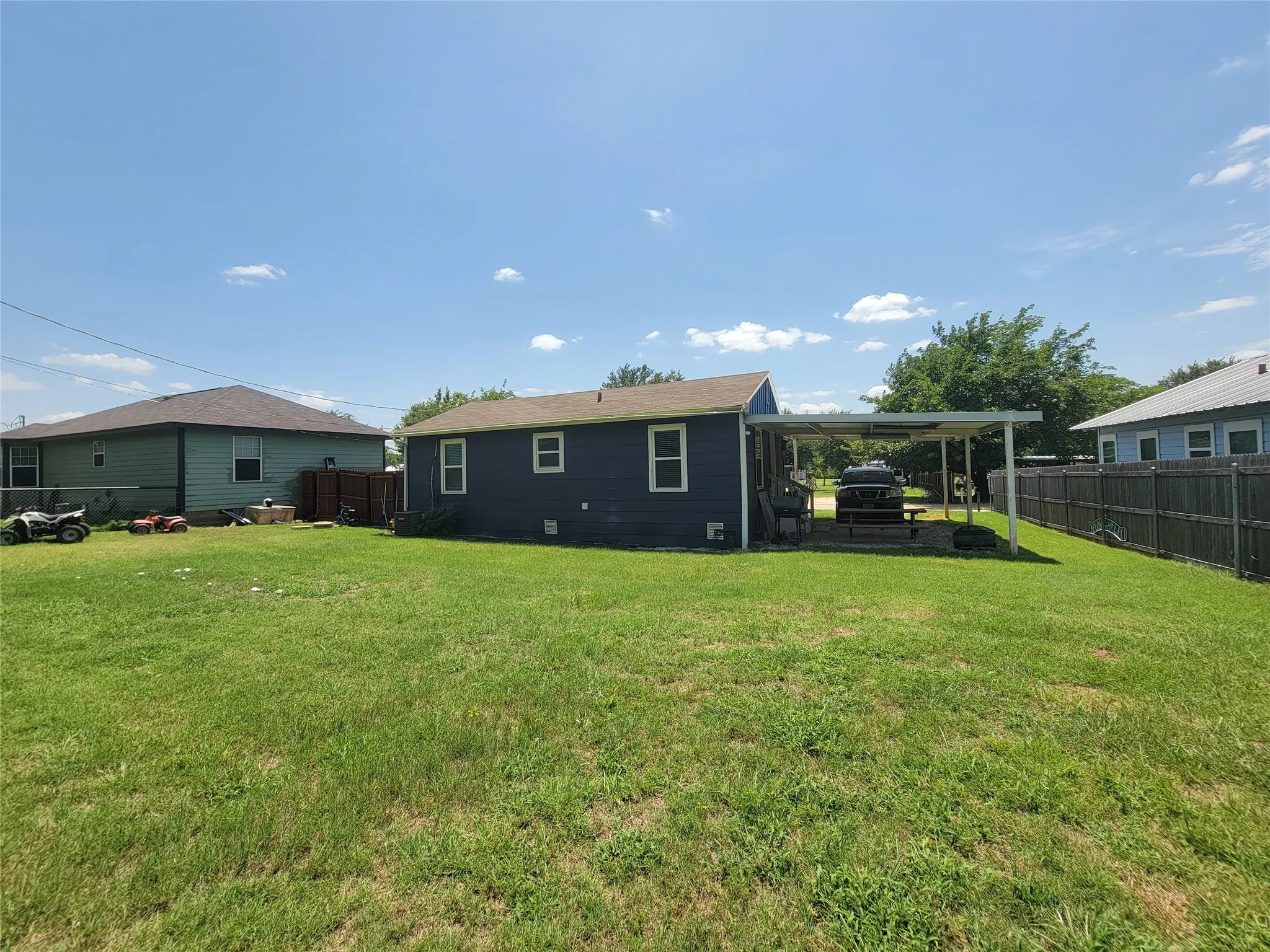 Expansive green lawn surrounds the property