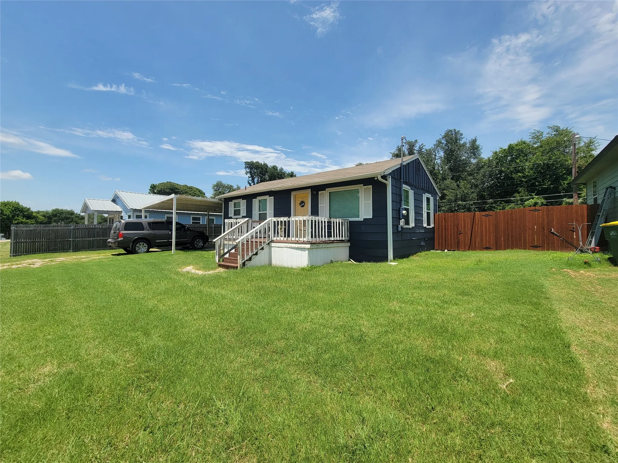 Single-story residence featuring a dark blue exterior with white trim