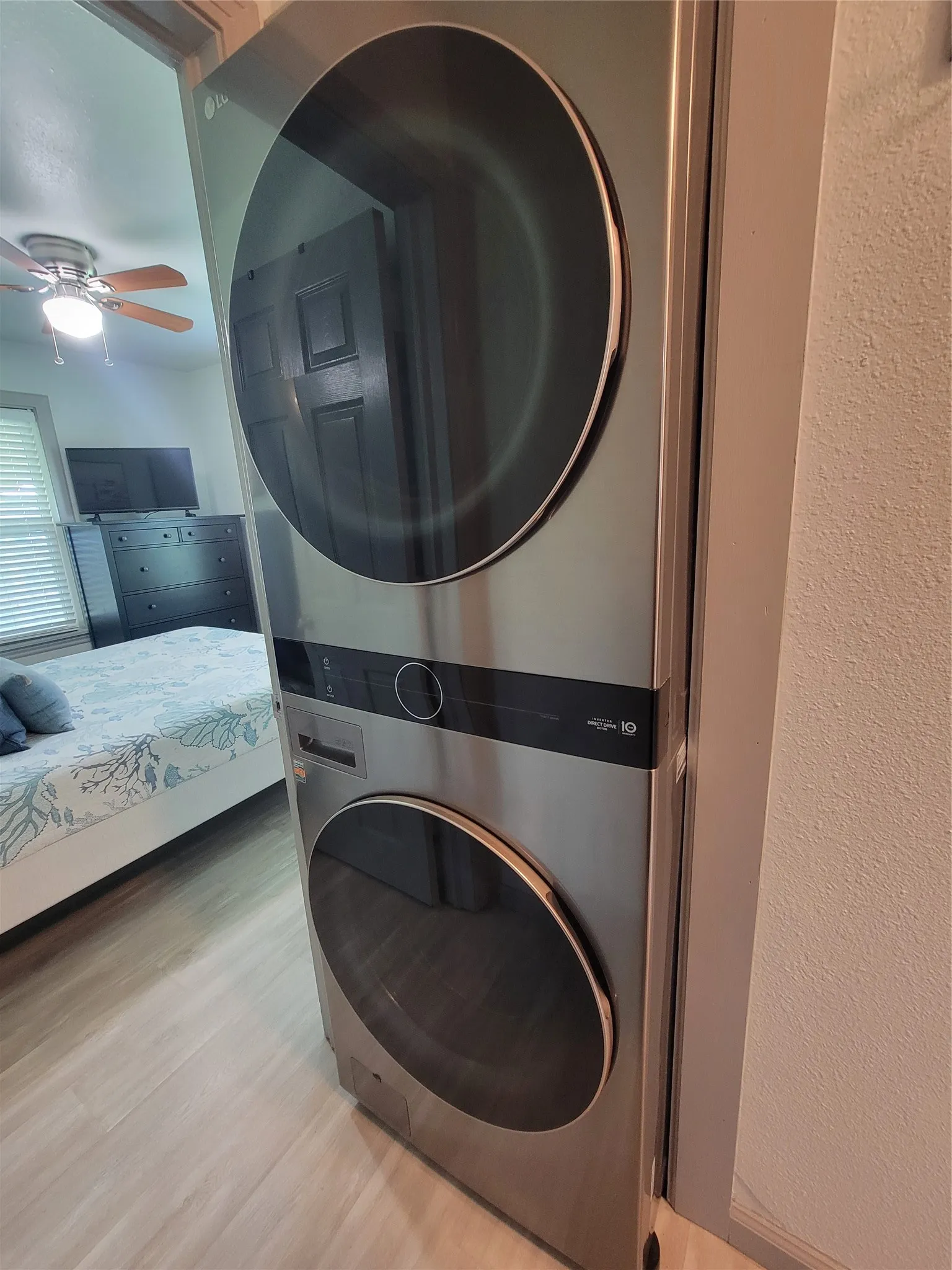 Stacked stainless steel laundry appliances with front-loading doors