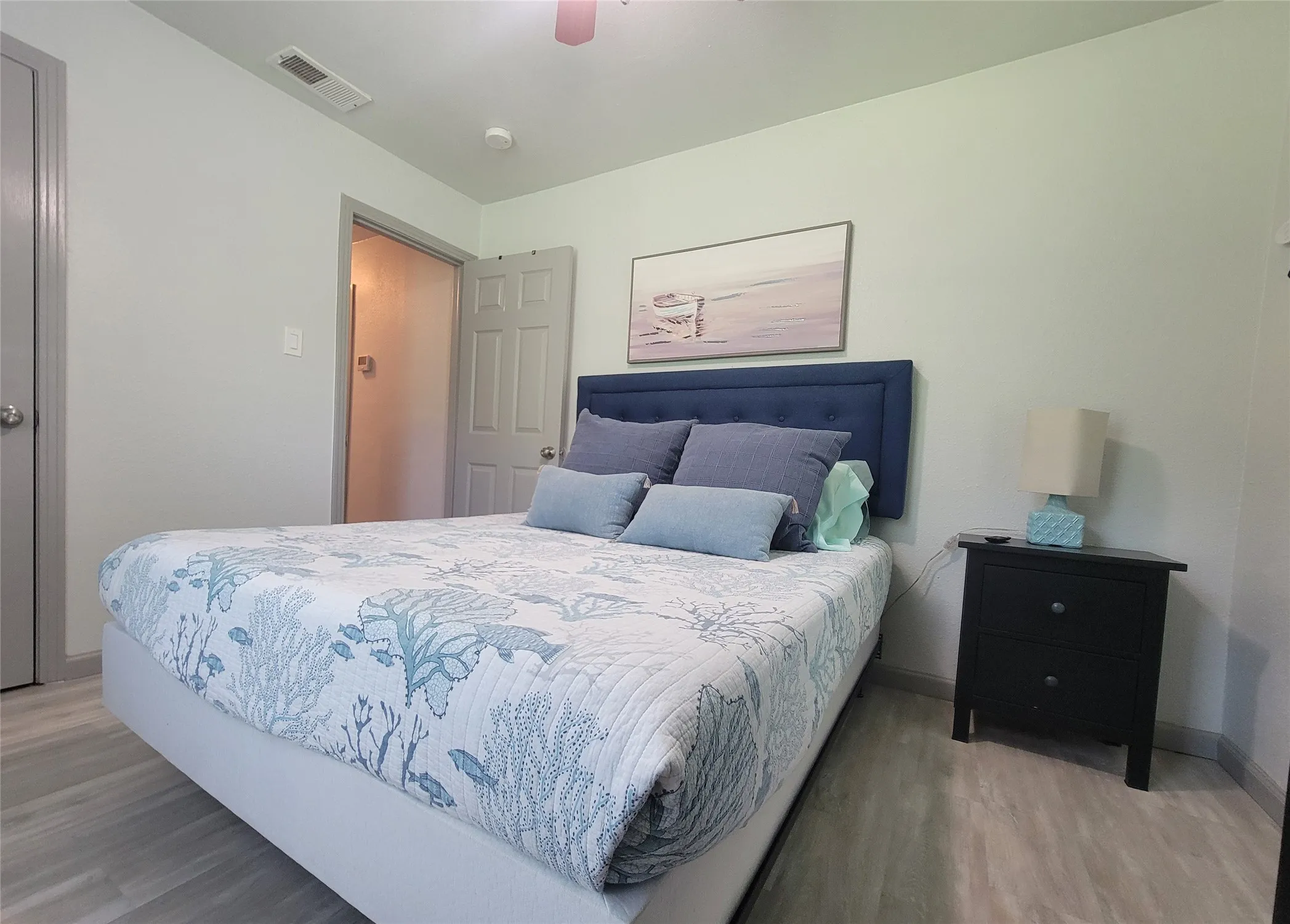 Light gray wood-finish flooring complements the room's neutral wall tones