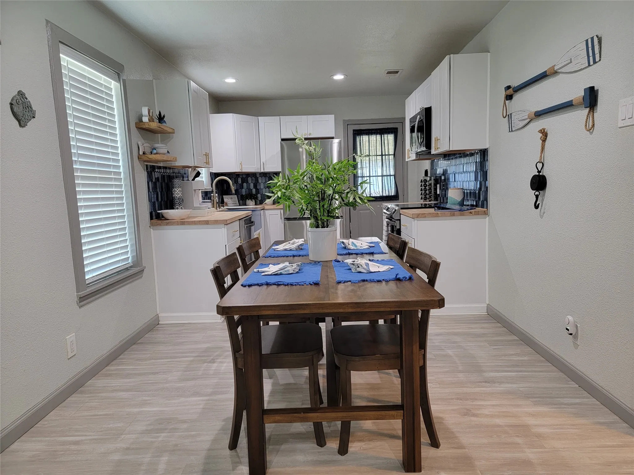 Open-concept dining area featuring light wood-finish flooring