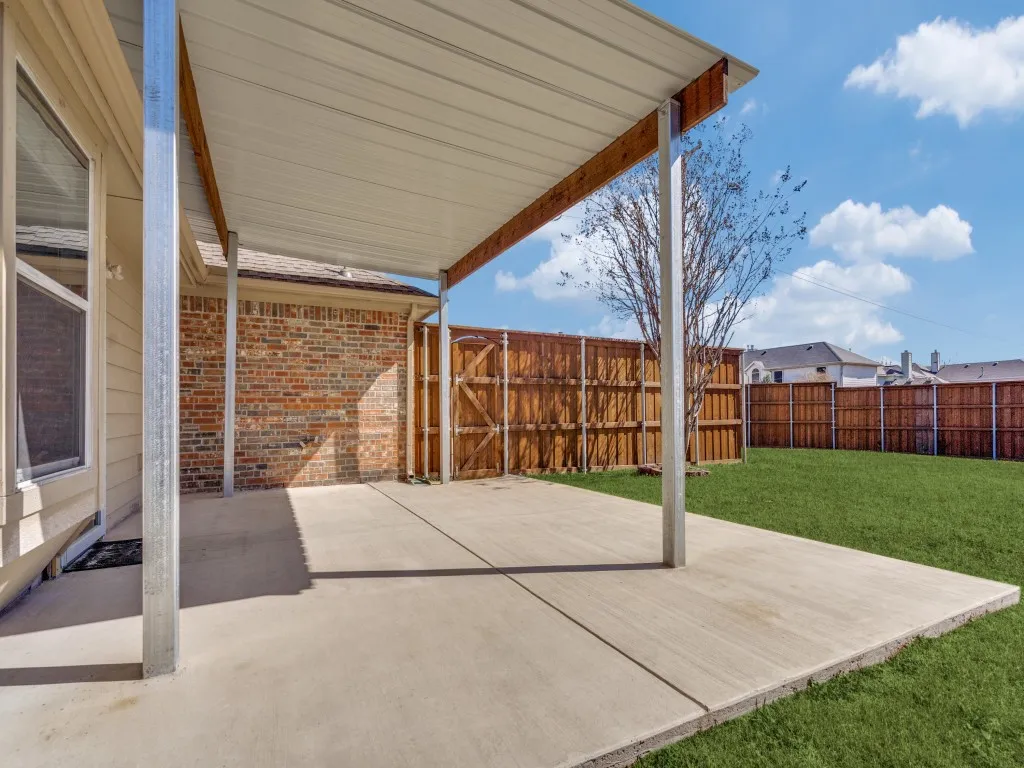 View of patio featuring fence