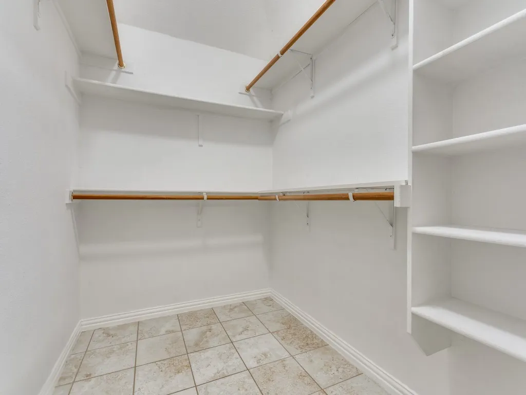 Spacious closet with light tile patterned flooring