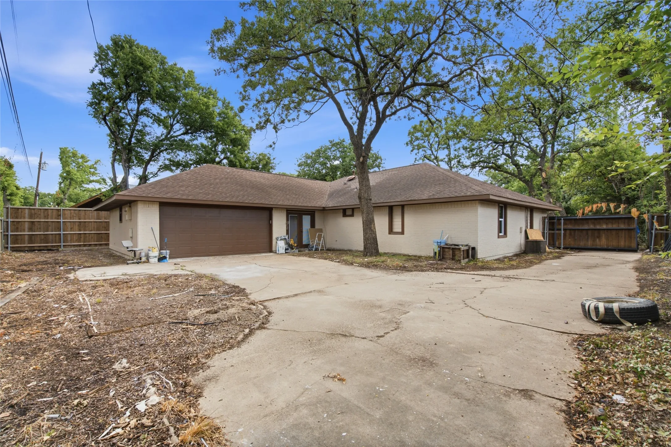 Single-story residence featuring a brown asphalt shingle roof and a light-colored stucco exterior