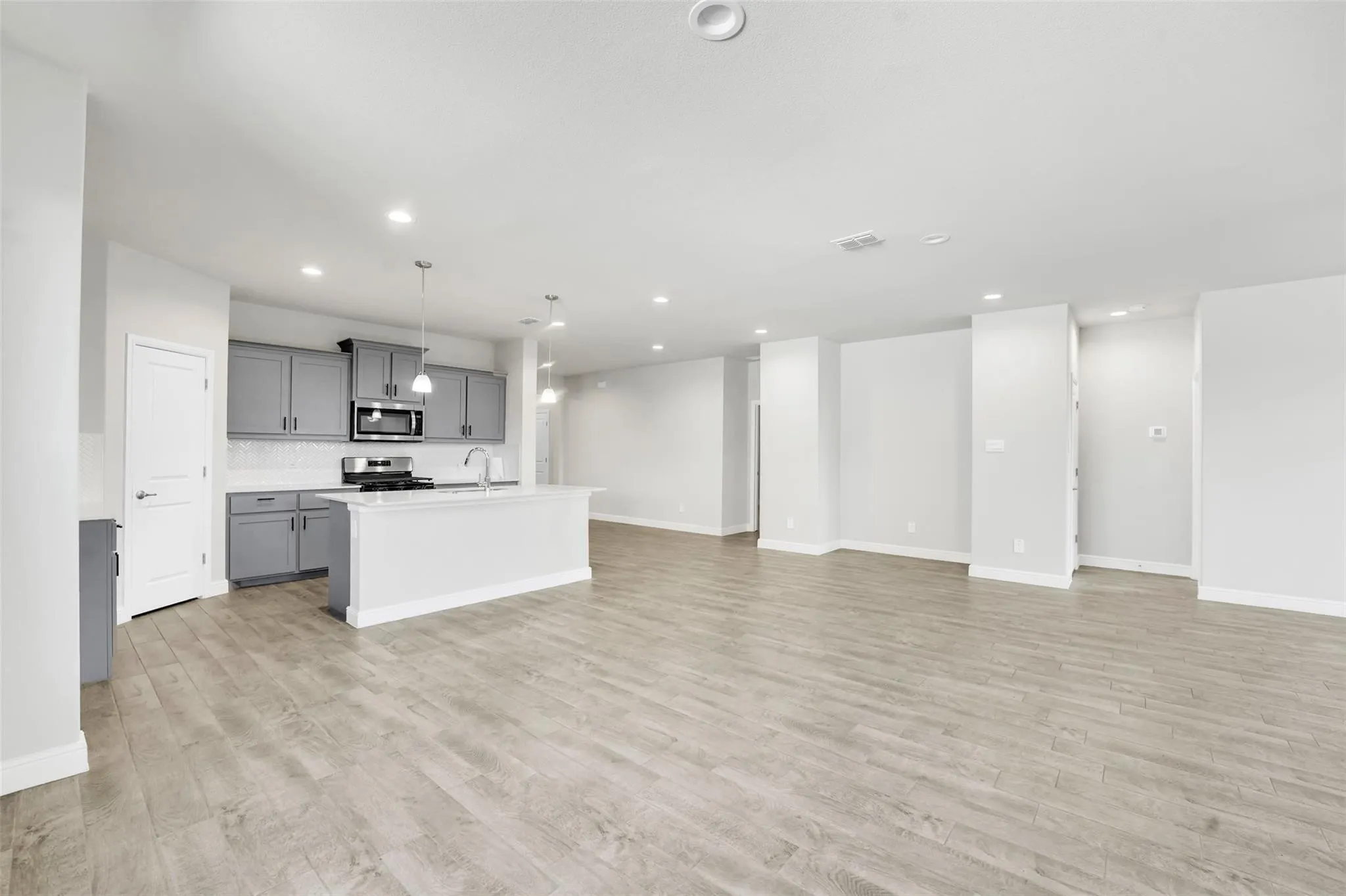 Open-concept living area with wood-finish flooring