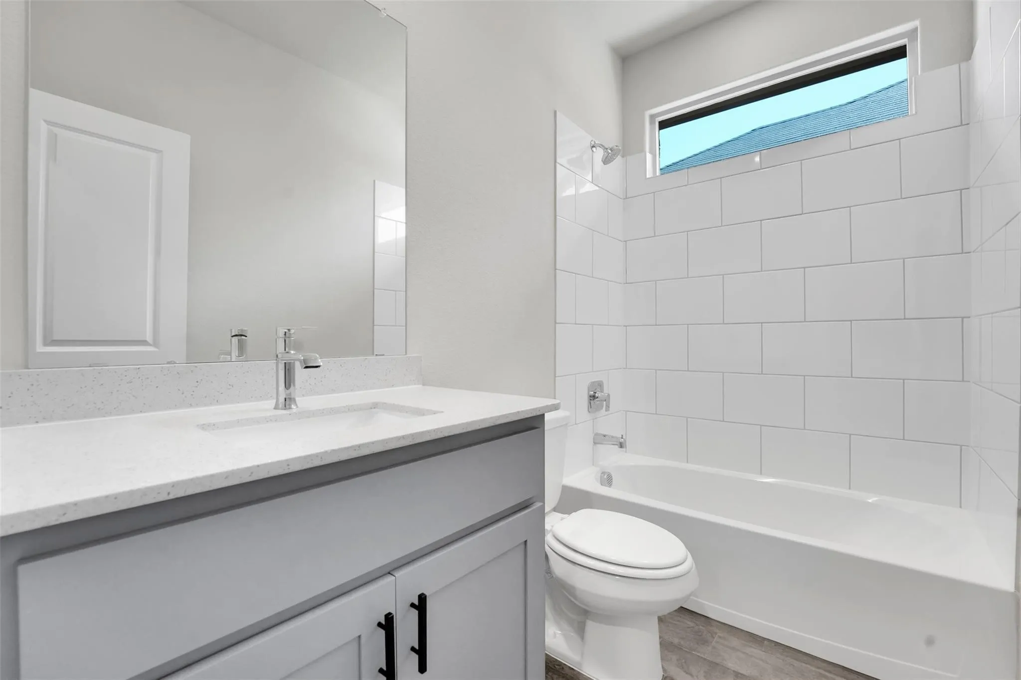 Bathroom featuring a light gray vanity with a white countertop and undermount sink