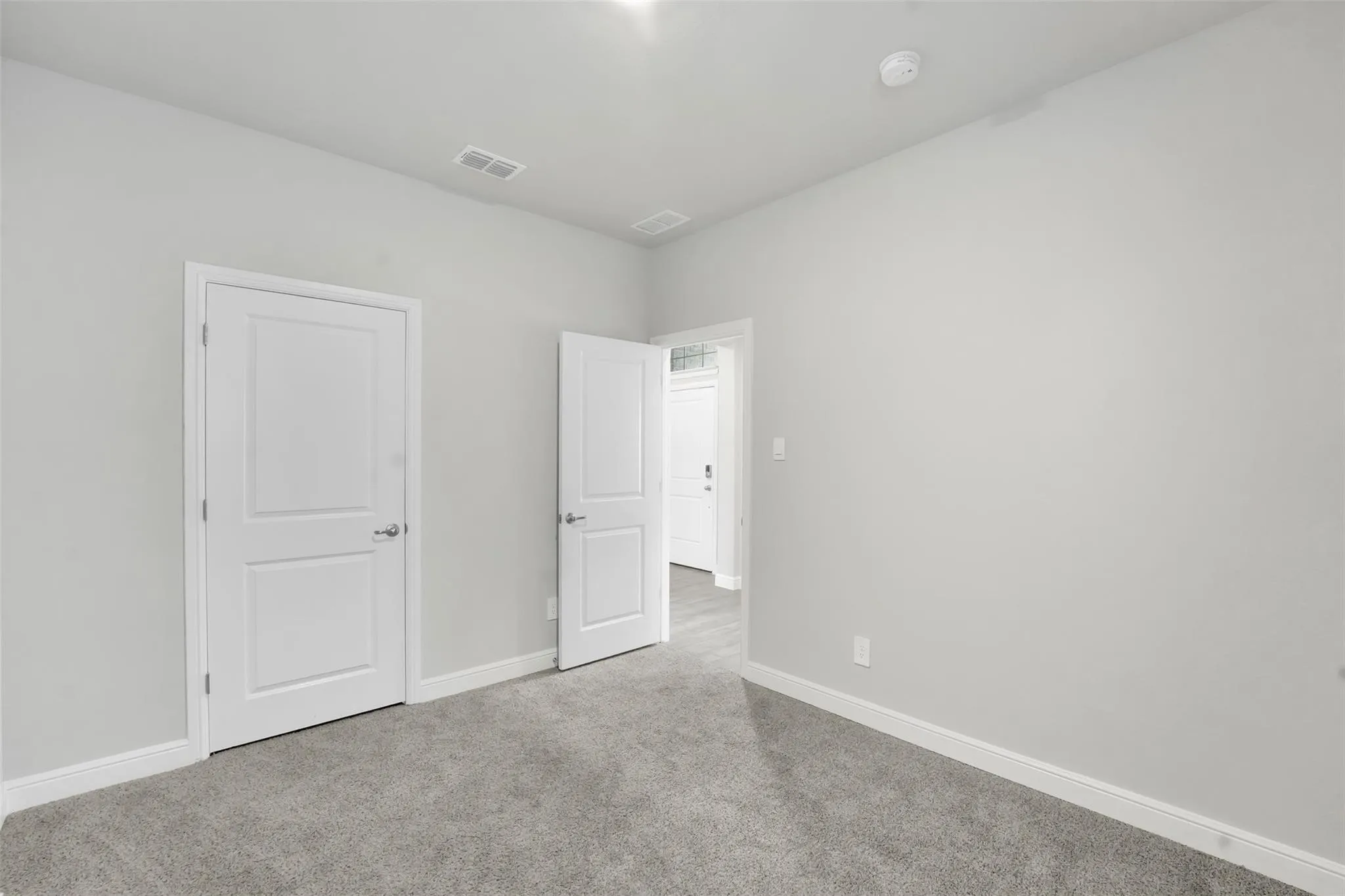 Neutral gray walls with white baseboards and trim
