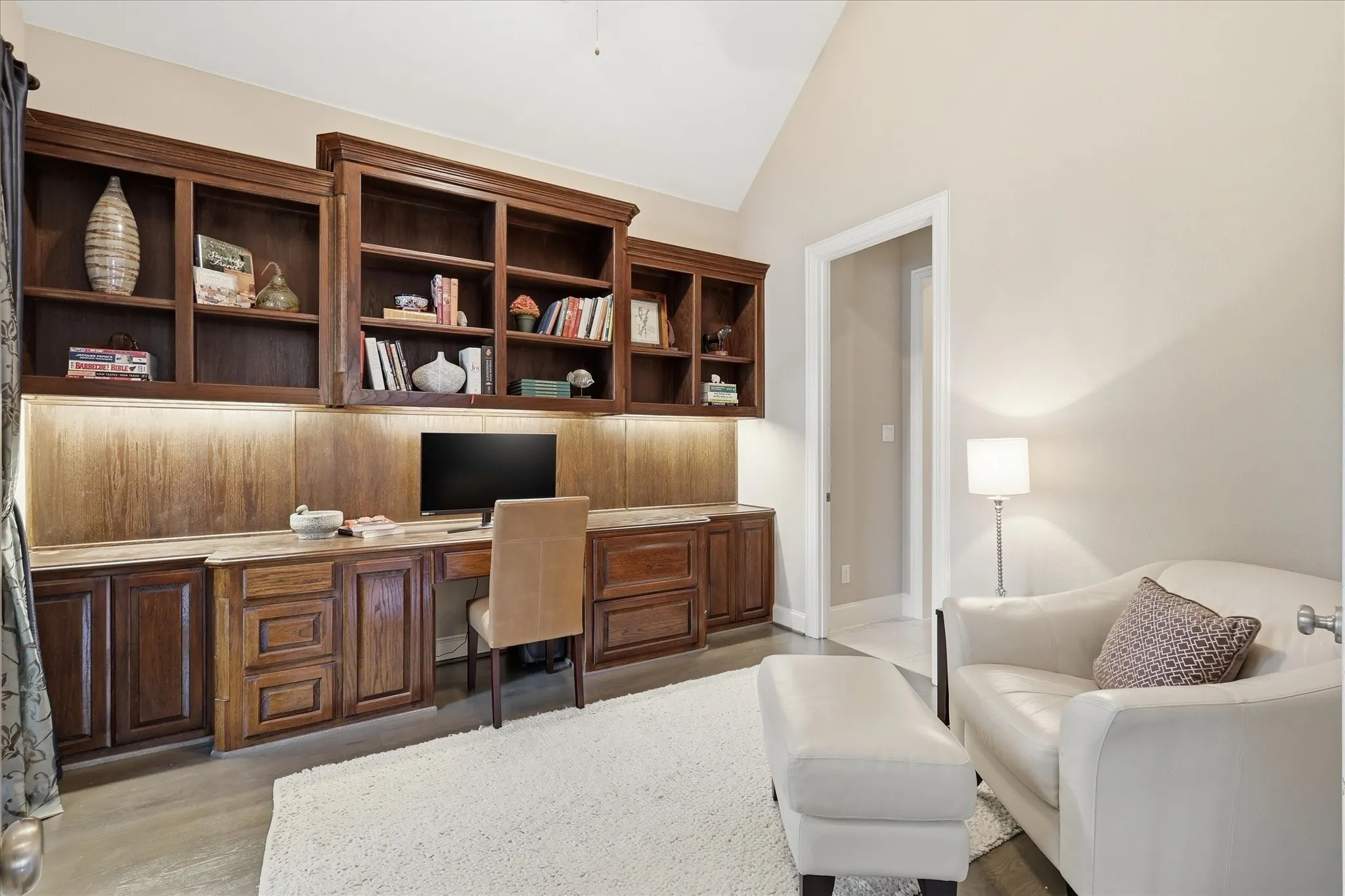 This inviting office with great built ins  opens to the front porch creating an inspiring workspace