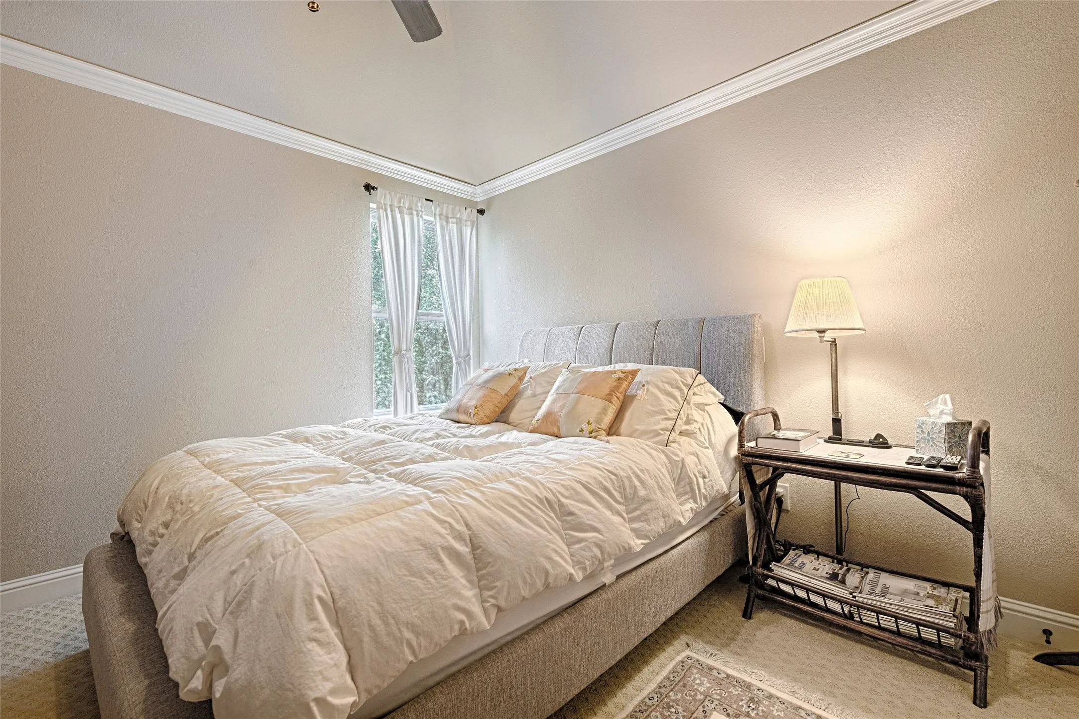 Bedroom featuring a window with natural light, crown molding, a ceiling fan, and carpeted flooring