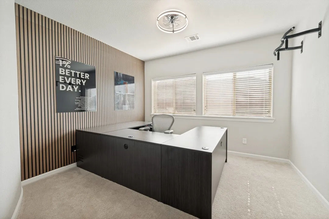 Flex 5th bedroom featuring a decorative wood-slat accent wall, two large windows with blinds, a ceiling-mounted light fixture, and neutral carpet flooring