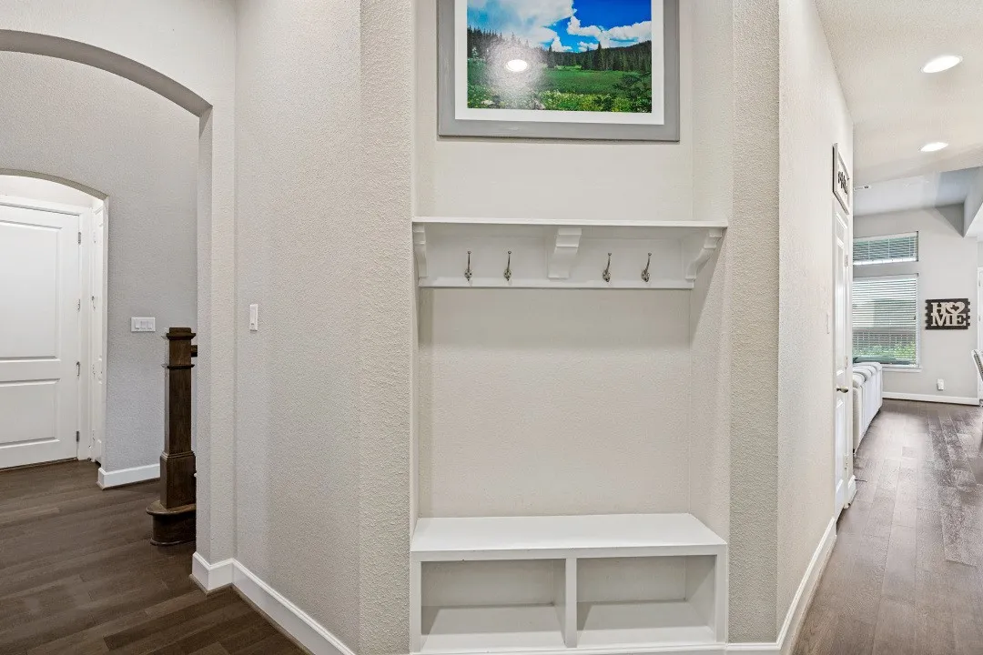 Built-in hall tree with storage bench and coat hooks, featuring a crisp white finish