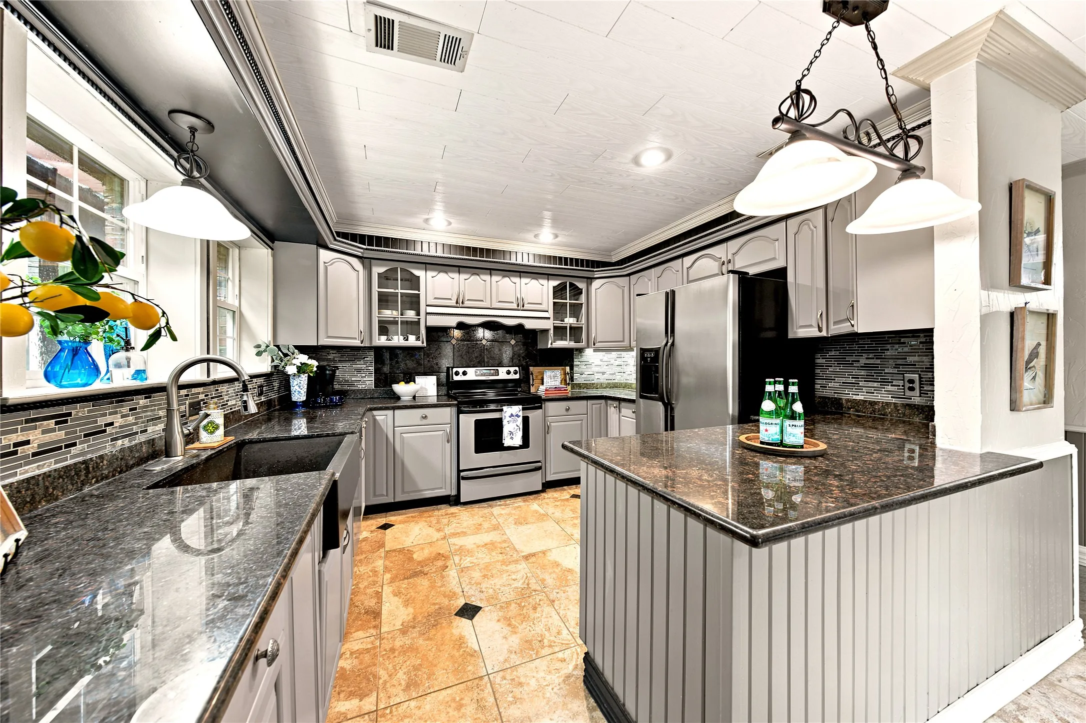 Granite, large sink, island, lots of windows