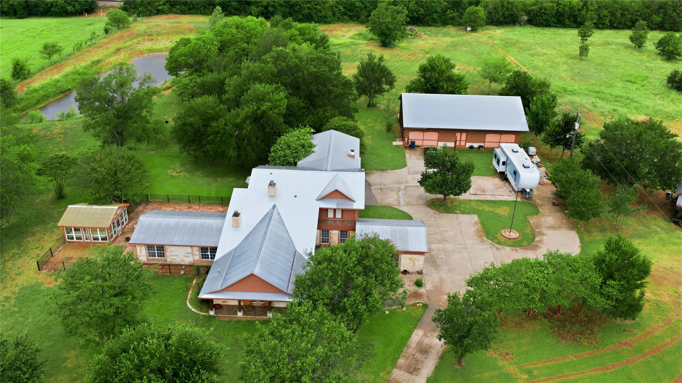 View of all living areas:  Home, workshop, greenhouse, She-Shed, connected garage