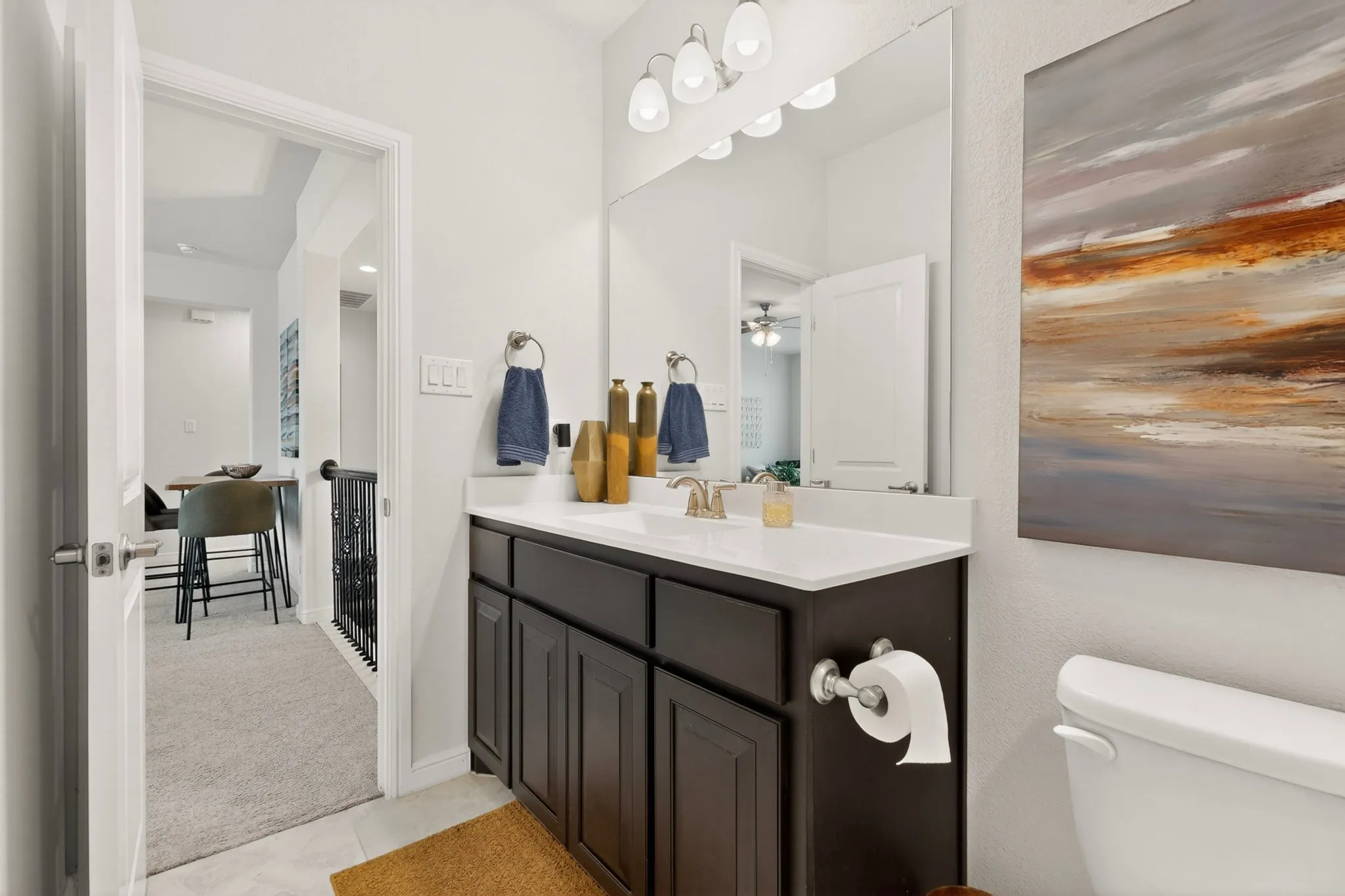 Bathroom featuring a dark wood-finish vanity with a white countertop and integrated sink.  Secondary bathroom located on level 2