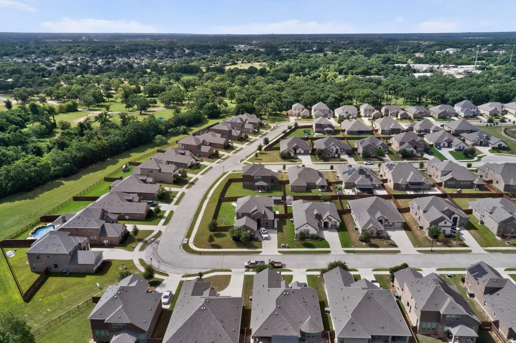 Aerial perspective showcasing a residential community with mature landscaping