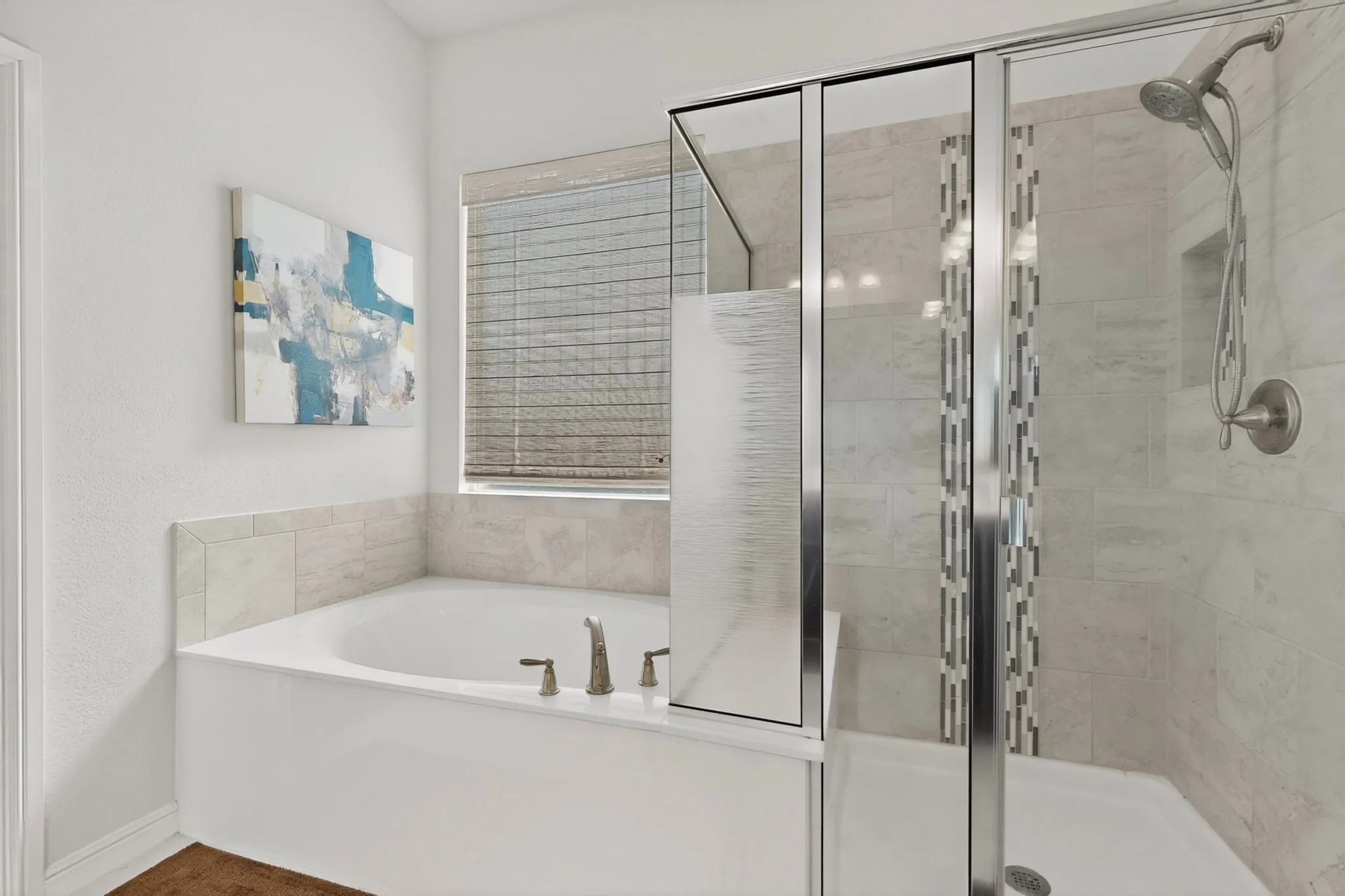 Enclosed shower with glass doors and tile surround, featuring a built-in shower niche