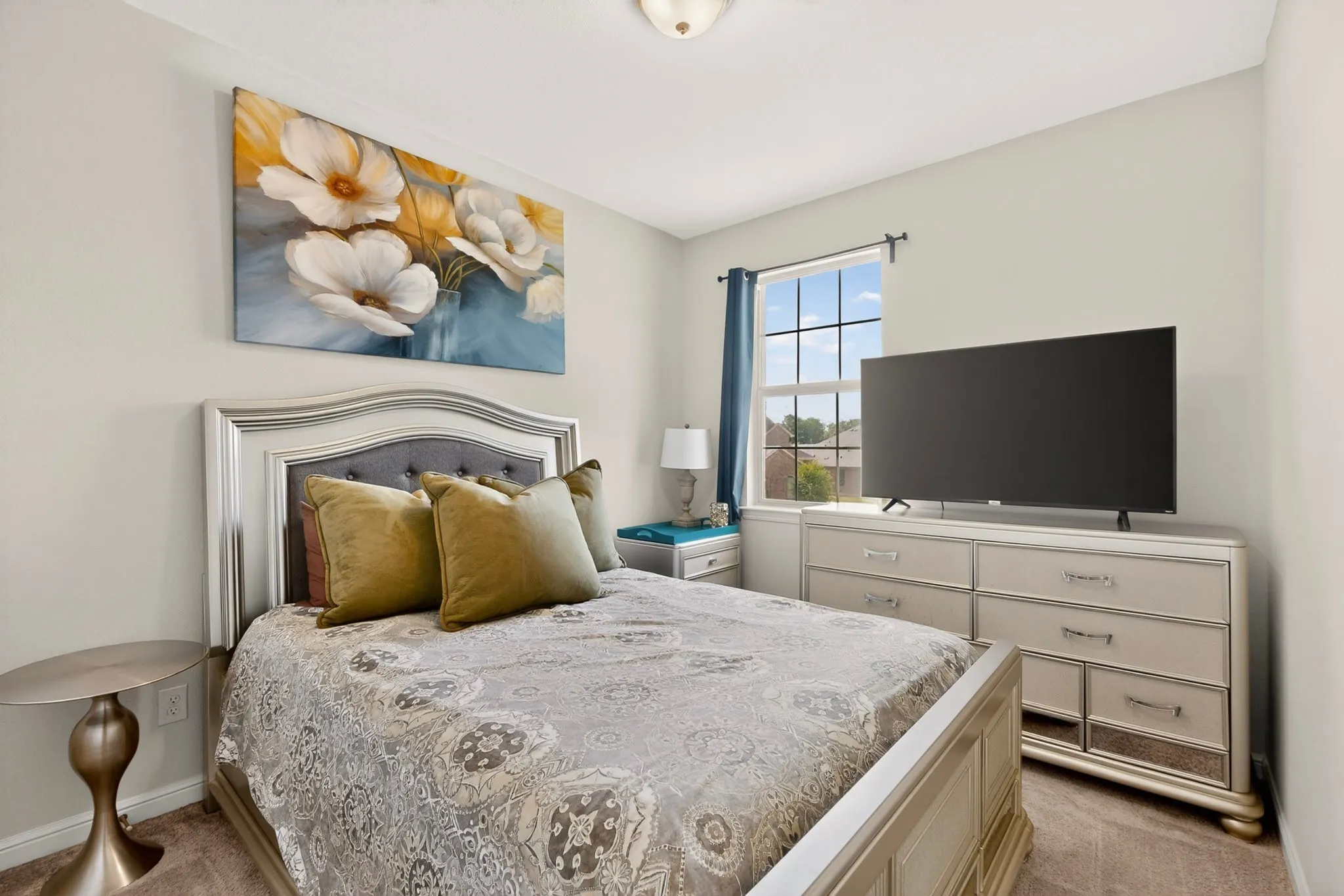 Carpeted room with a single window featuring a light fixture, light gray walls, and a built-in closet