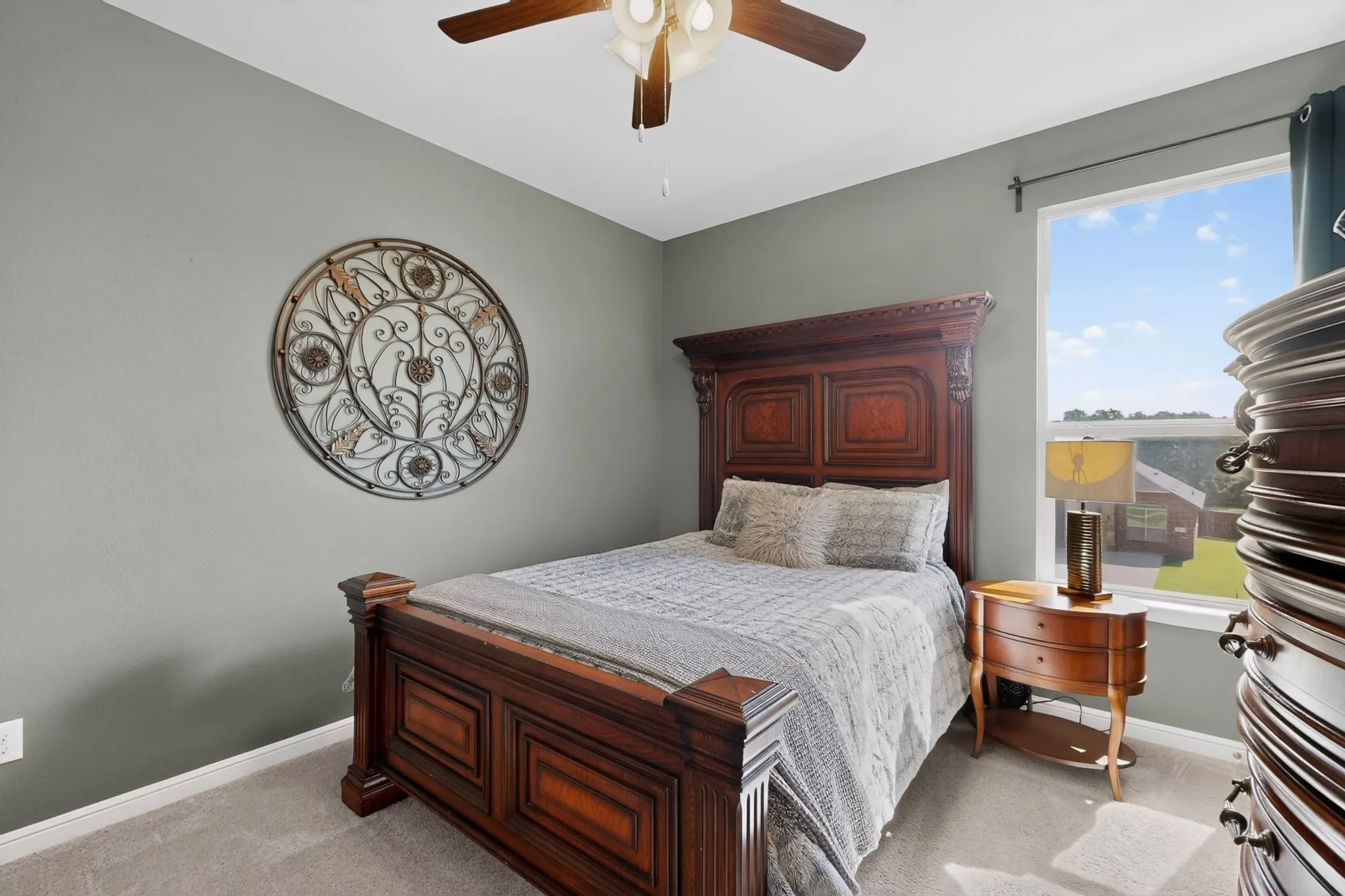 Carpeted room featuring a ceiling fan with integrated lighting, a window, and neutral wall paint
