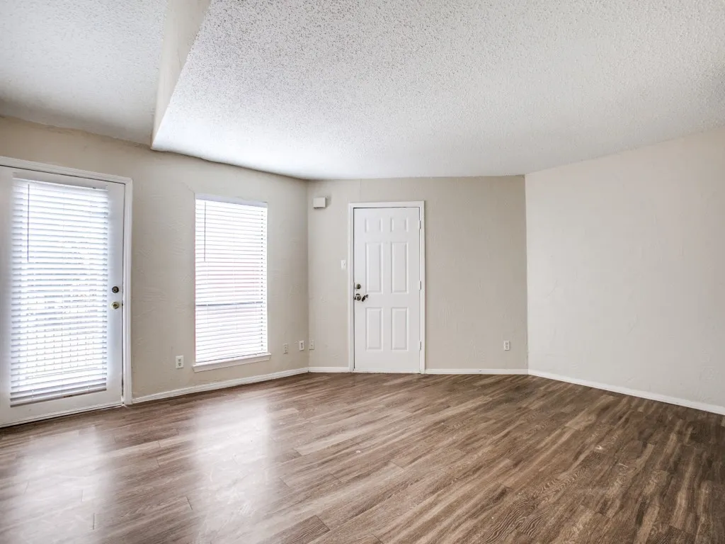 Spare room with a textured ceiling and wood-type flooring