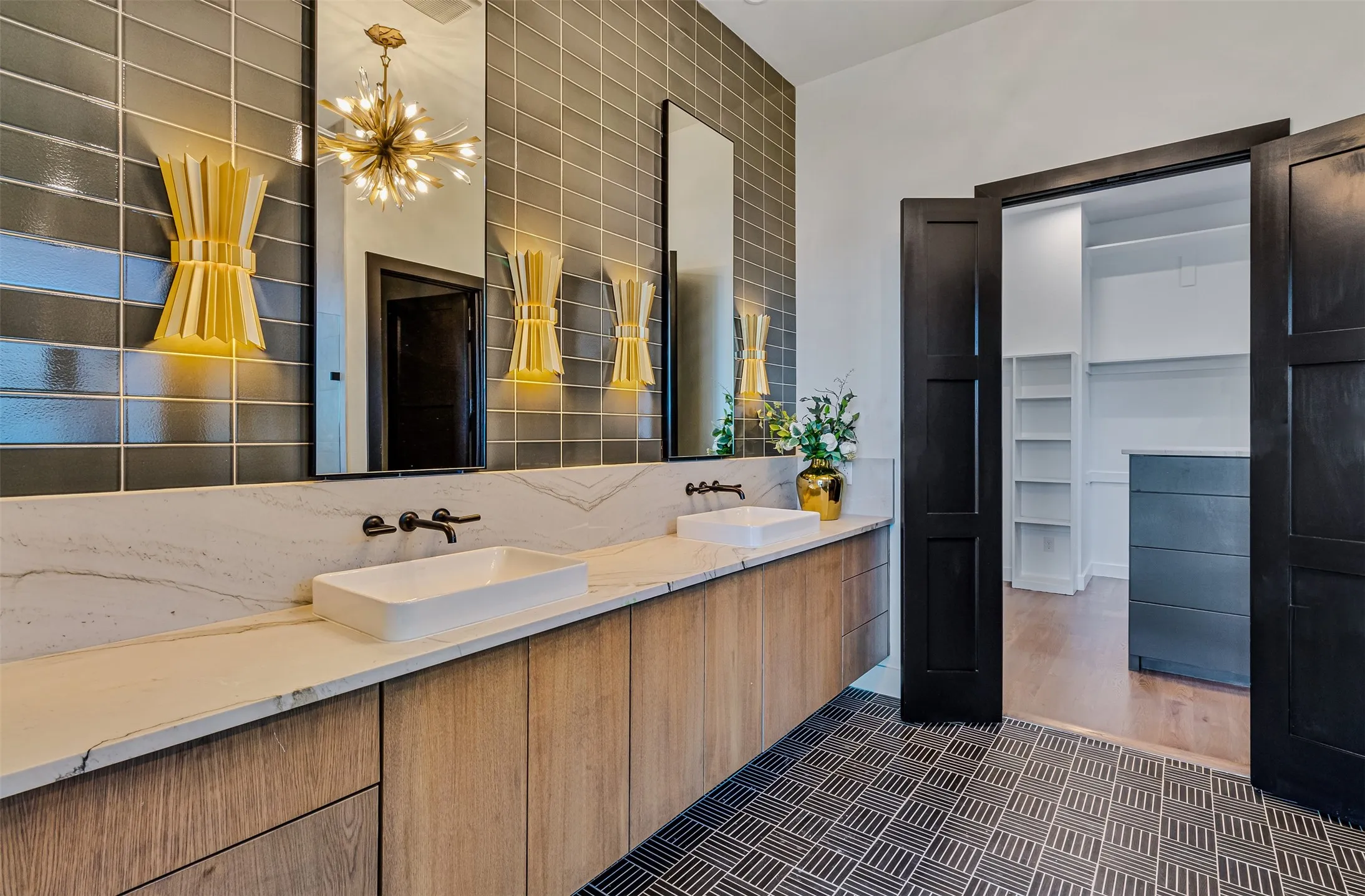 Dual vanity featuring rectangular vessel sinks, wall-mounted matte black faucets, and a white stone-finish countertop